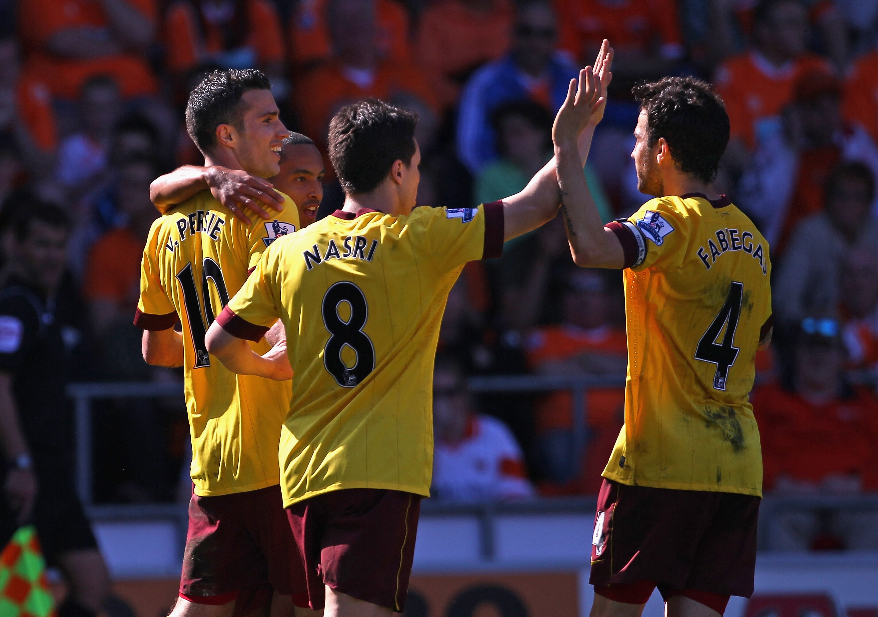 BLACKPOOL, ENGLAND - APRIL 10:  Robin Van Persie of Arsenal celebrates with team mates after scoring the third goal for Arsenal during the Barclays Premier League match between Blackpool and Arsenal at Bloomfield Road on April 10, 2011 in Blackpool, Engla