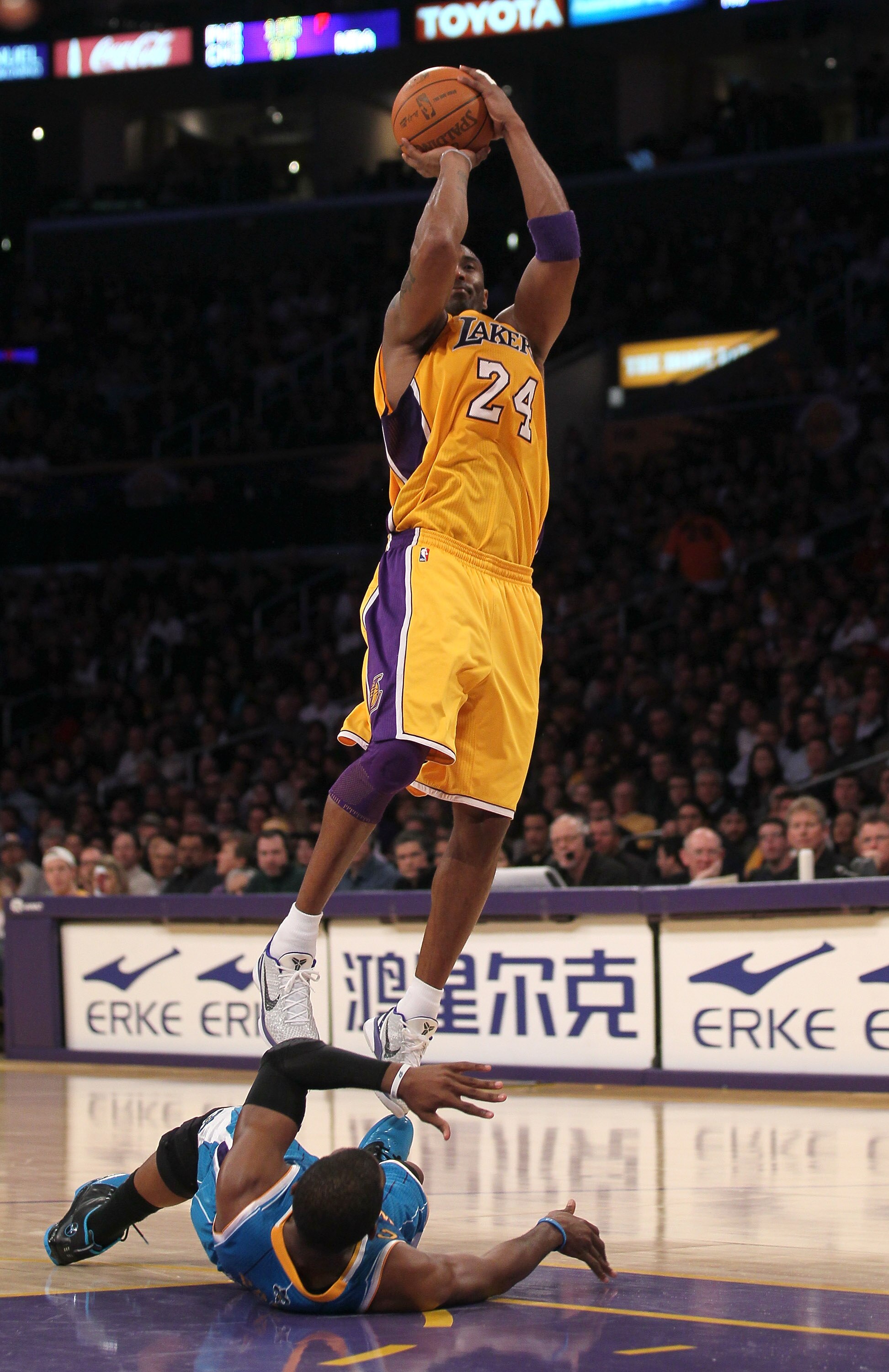 LOS ANGELES, CA - JANUARY 07:  Kobe Bryant #24 of the Los Angeles Lakers shoots over fallen Chris Paul #3 of the New Orleans Hornets at Staples Center on January 7, 2011 in Los Angeles, California.  The Lakers won 101-97.  NOTE TO USER: User expressly ack