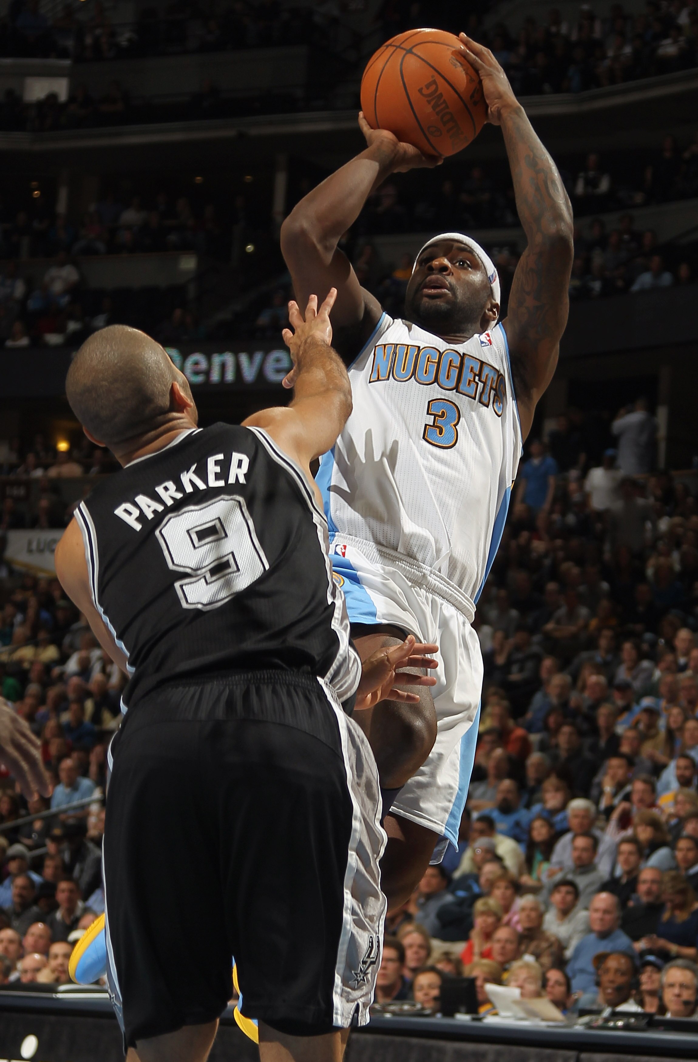 DENVER, CO - MARCH 23:  Ty Lawson #3 of the Denver Nuggets takes a shot over Tony Parker #9 of the San Antonio Spurs at the Pepsi Center on March 23, 2011 in Denver, Colorado. The Nuggets defeated the Spurs 115-112. NOTE TO USER: User expressly acknowledg