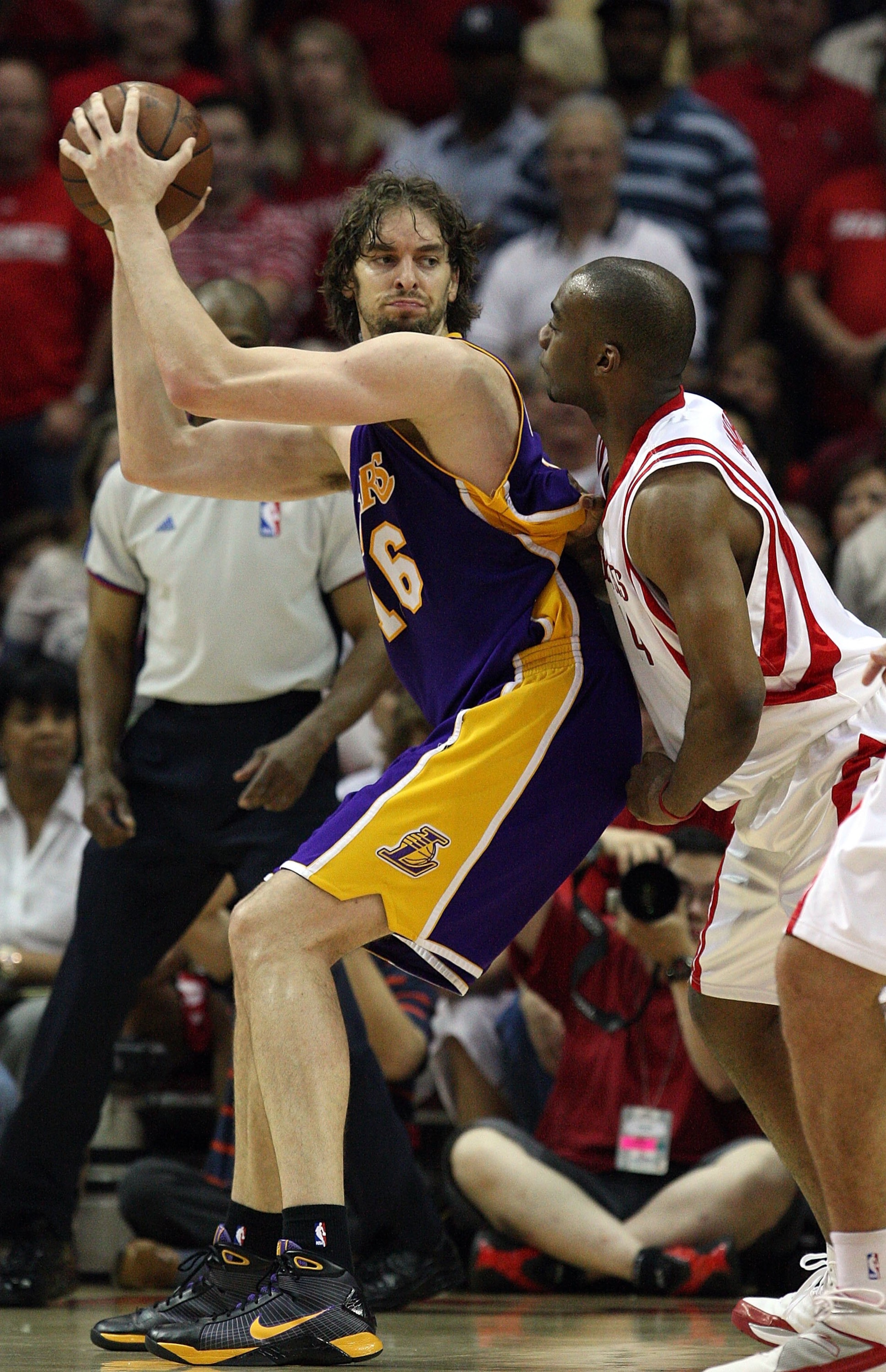 HOUSTON - MAY 14:  Center Pau Gasol #16 of the Los Angeles Lakers dribbles the ball against Carl Landry #14 of the Houston Rockets in Game Six of the Western Conference Semifinals during the 2009 NBA Playoffs at Toyota Center on May 14, 2009 in Houston, T