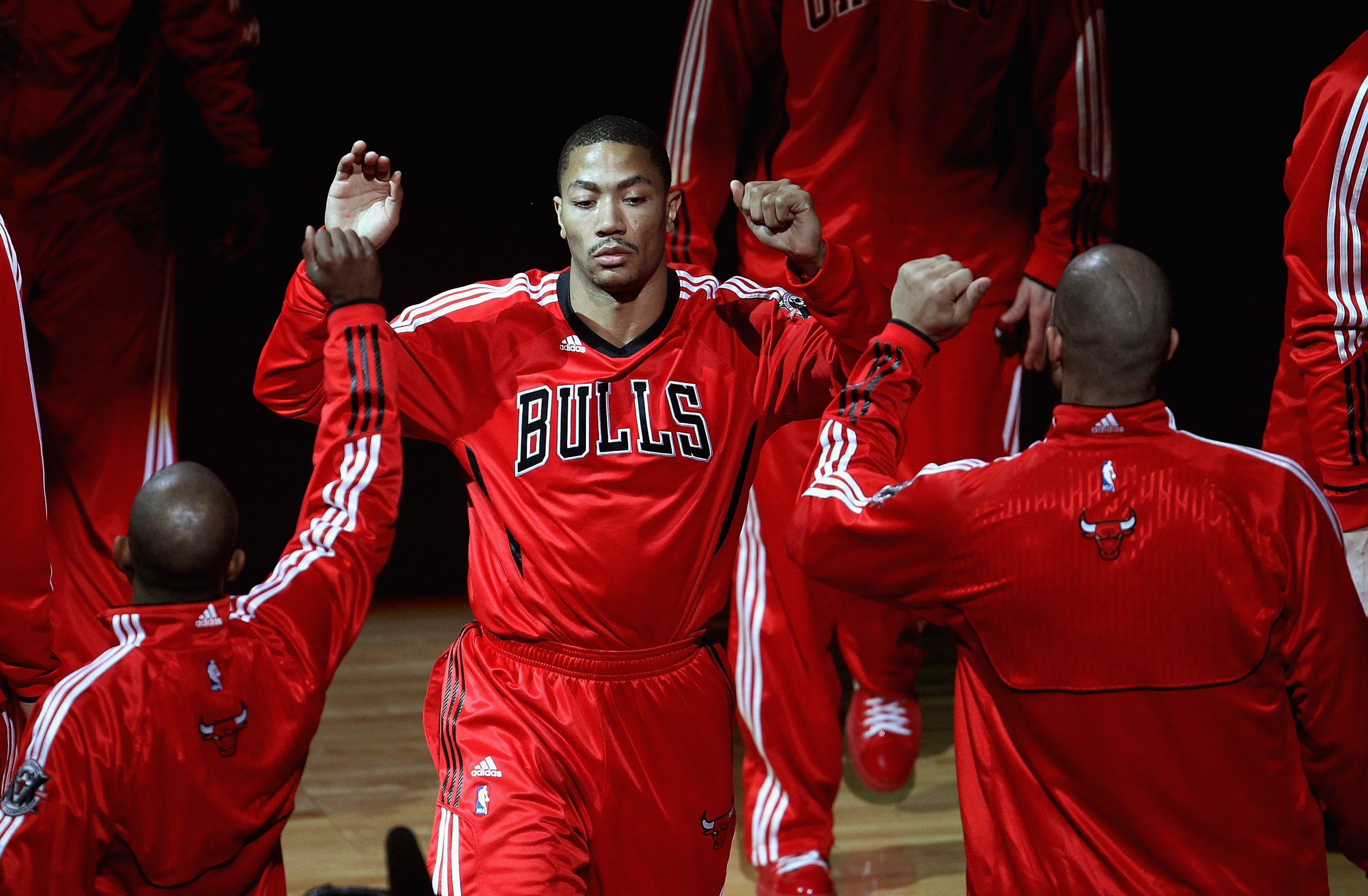 CHICAGO, IL - APRIL 13: Derrick Rose #1 of the Chicago Bulls is greeted by teammates during player introductions before a game against the New Jersey Nets at United Center on April 13, 2011 in Chicago, Illinois. The Bulls defeated the Nets 97-92. NOTE TO