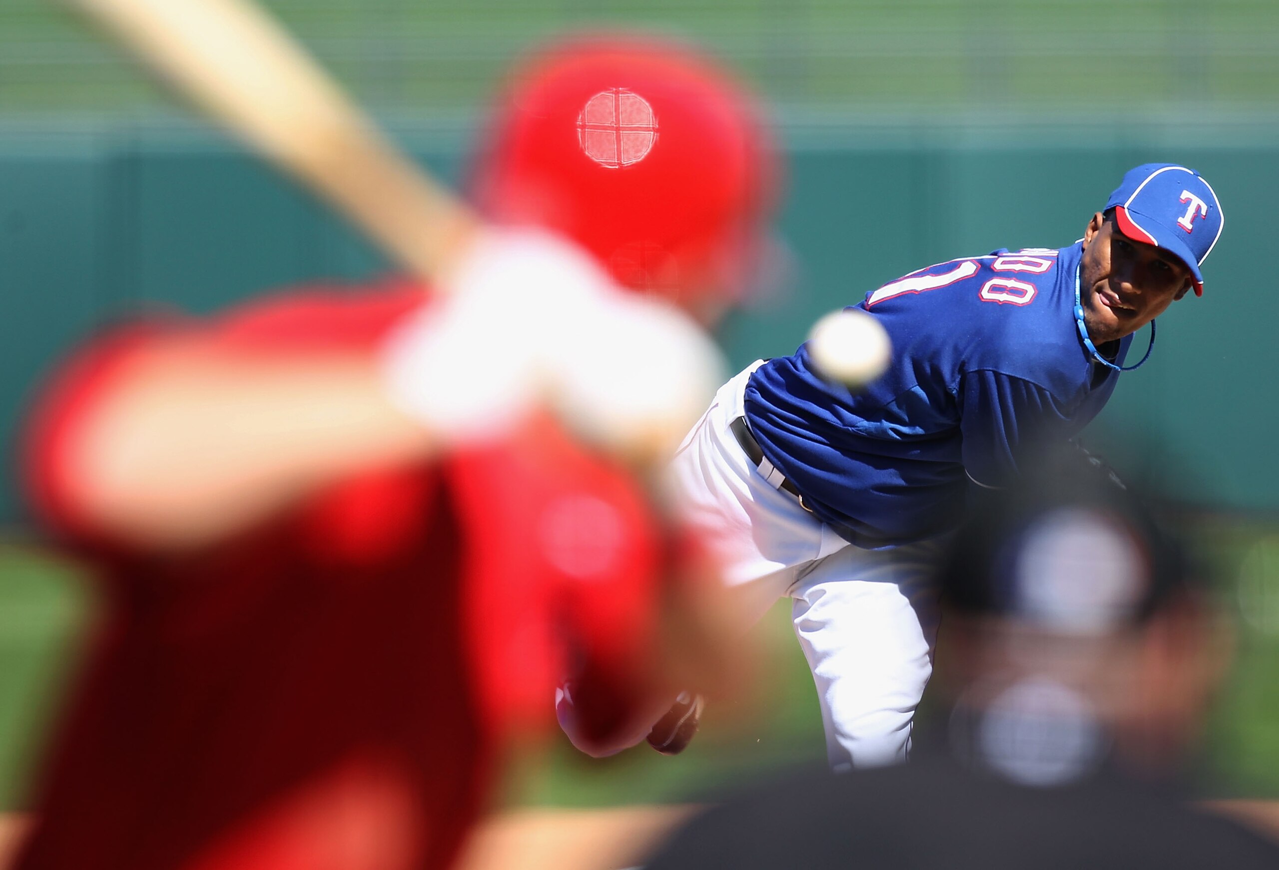 SURPRISE, AZ - MARCH 02:  Relief pitcher Alexi Ogando #41 of the Texas Rangers pitches to Mike Trout #90 of the Los Angeles Angels of Anaheim during the spring training game at Surprise Stadium on March 2, 2011 in Surprise, Arizona.  (Photo by Christian P