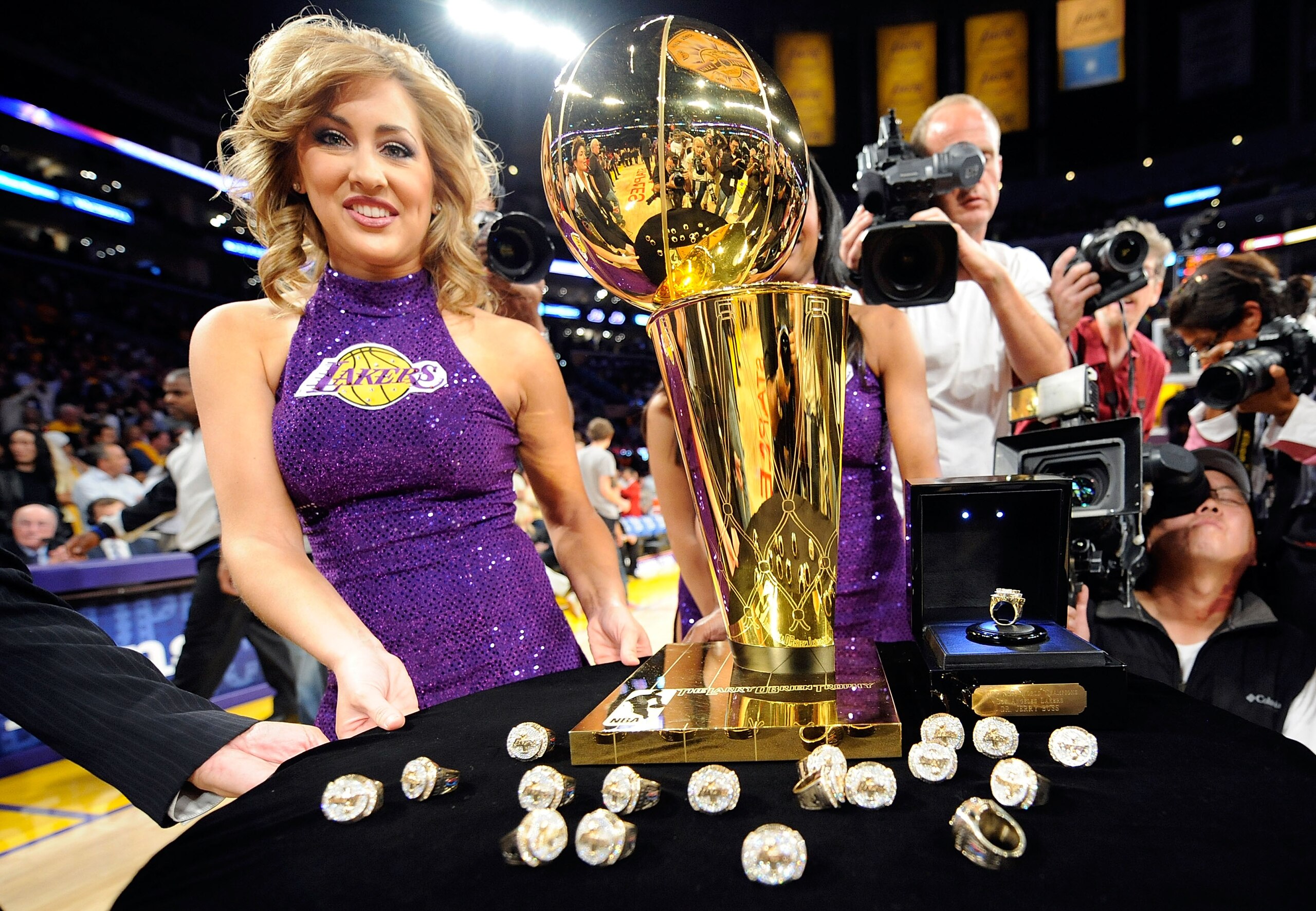 LOS ANGELES, CA - OCTOBER 27:  A member of the Laker Girls poses with the Larry O'Brien championship trophy and rings to be presented to the Los Angeles Lakers before the season opening game against the Los Angeles Clippers at Staples Center on October 27