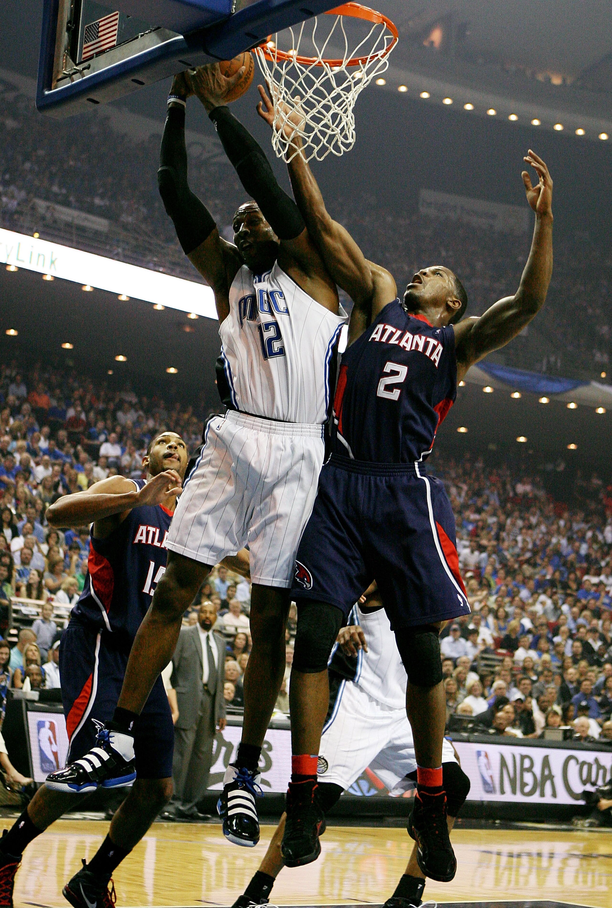 ORLANDO, FL - MAY 06: Dwight Howard #12 of the Orlando Magic grabs a rebound over Joe Johnson #2 of the Atlanta Hawks in Game Two of the Eastern Conference Semifinals during the 2010 NBA Playoffs at Amway Arena on May 6, 2010 in Orlando, Florida. NOTE TO