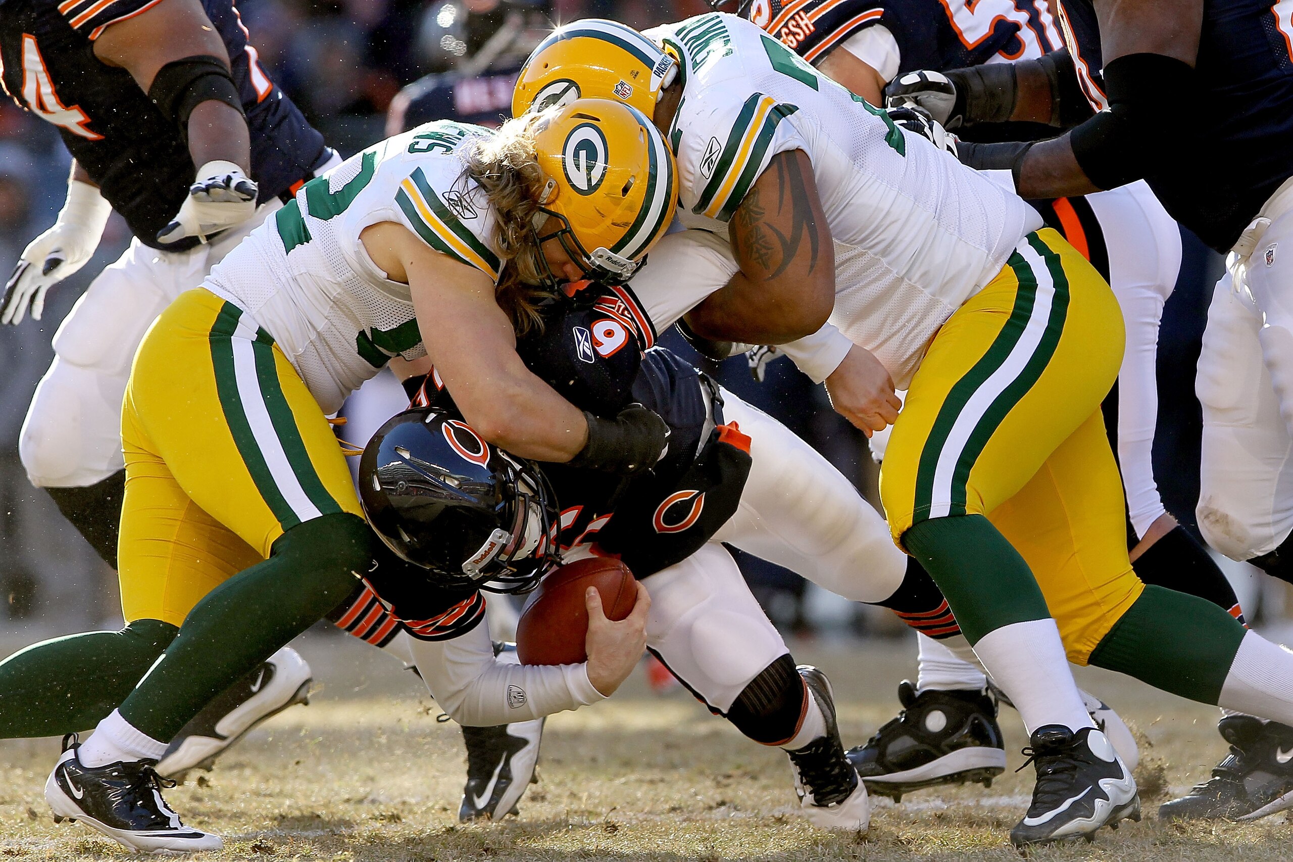 CHICAGO, IL - JANUARY 23:  Linebacker Clay Matthews #52 and Cullen Jenkins #77 of the Green Bay Packers sack quarterback Jay Cutler #6 of the Chicago Bears in the first half of the NFC Championship Game at Soldier Field on January 23, 2011 in Chicago, Ill