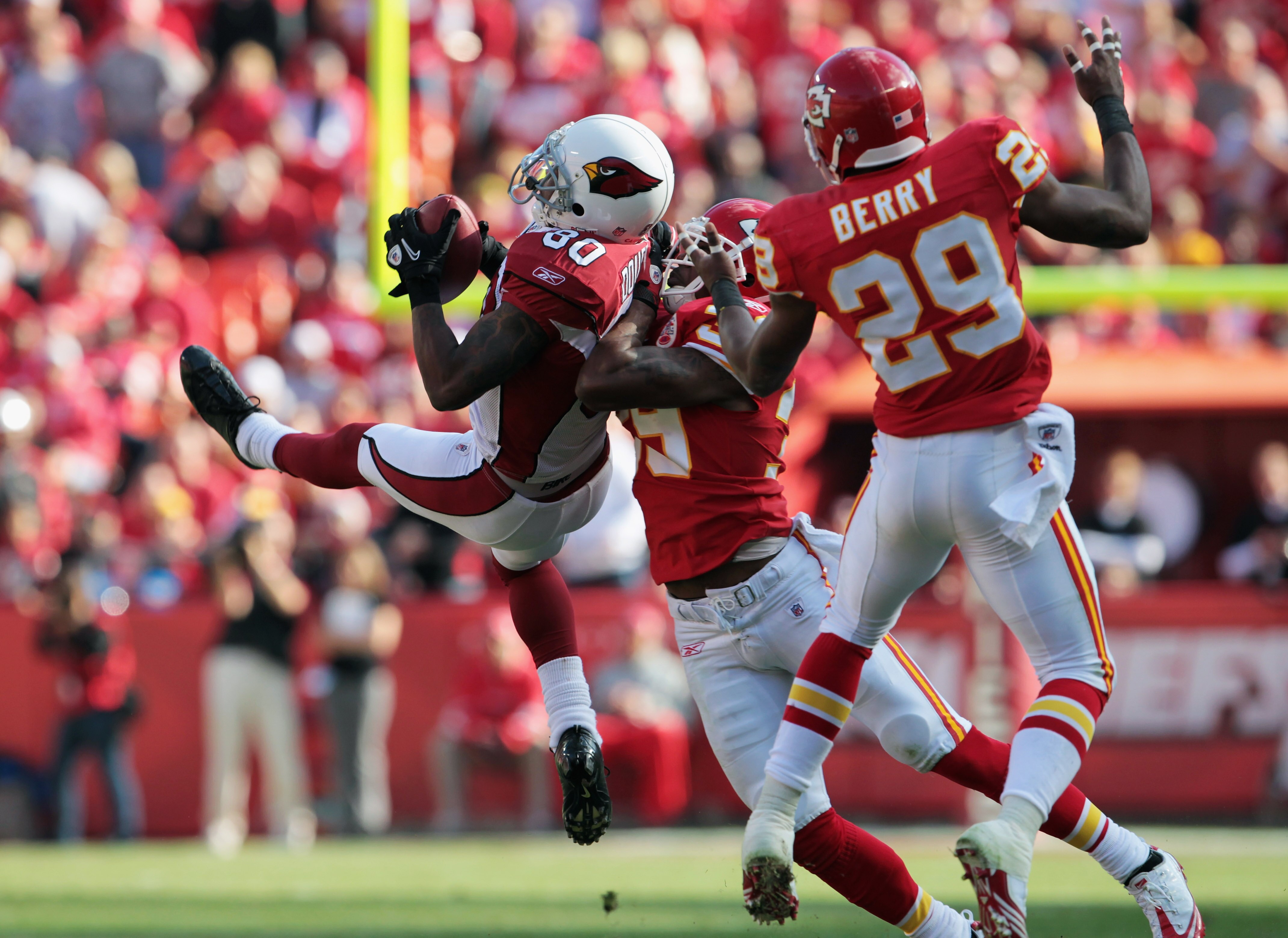 KANSAS CITY, MO - NOVEMBER 21:  Early Doucet #80 of the Arizona Cardinals attempts to catch the ball as Brandon Carr #39 and Eric Berry #29 of the Kansas City Chiefs defend during the game on November 21, 2010  at Arrowhead Stadium in Kansas City, Missour