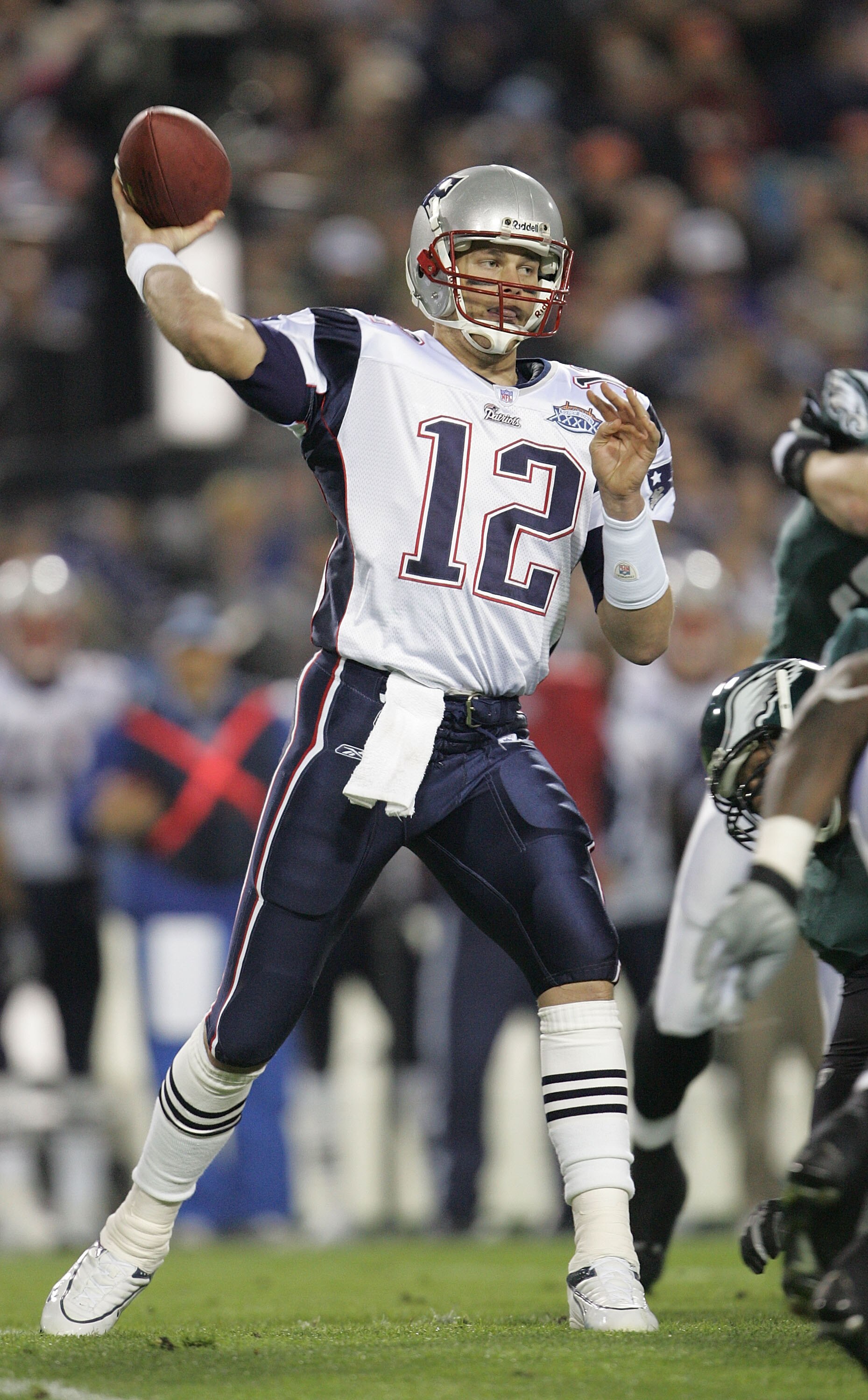JACKSONVILLE, FLORIDA - FEBRUARY 06:  Quarterback Tom Brady #12 of the New England Patriots delivers a pass against the Philadelphia Eagles in the first quarter of Super Bowl XXXIX at Alltel Stadium on February 6, 2005 in Jacksonville, Florida.  (Photo by