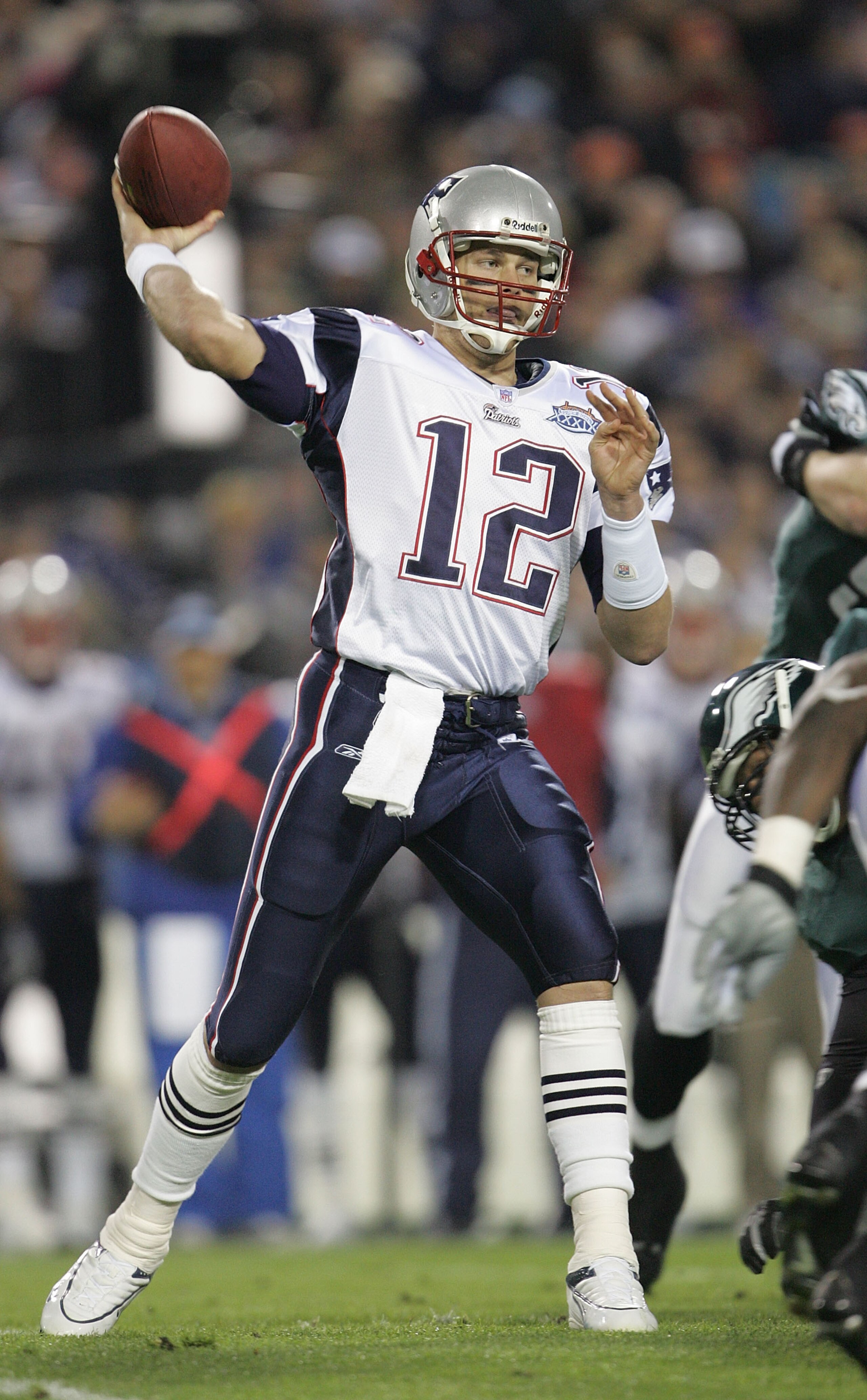 JACKSONVILLE, FLORIDA - FEBRUARY 06:  Quarterback Tom Brady #12 of the New England Patriots delivers a pass against the Philadelphia Eagles in the first quarter of Super Bowl XXXIX at Alltel Stadium on February 6, 2005 in Jacksonville, Florida.  (Photo by