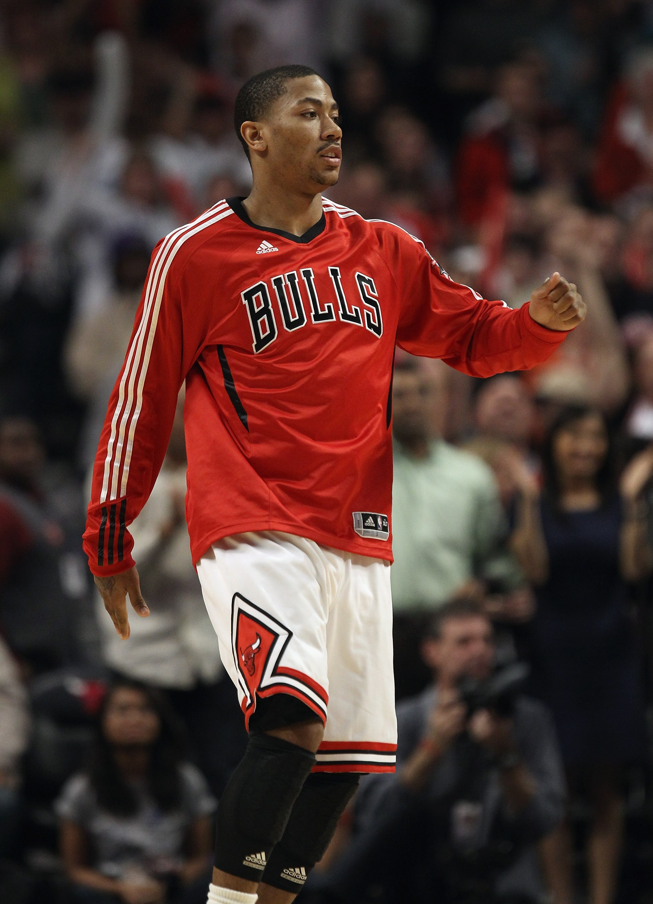 CHICAGO, IL - APRIL 13: Derrick Rose #1 of the Chicago Bulls moves off of the bench to greet teammates during a time-out against the New Jersey Nets at United Center on April 13, 2011 in Chicago, Illinois. The Bulls defeated the Nets 97-92. NOTE TO USER: