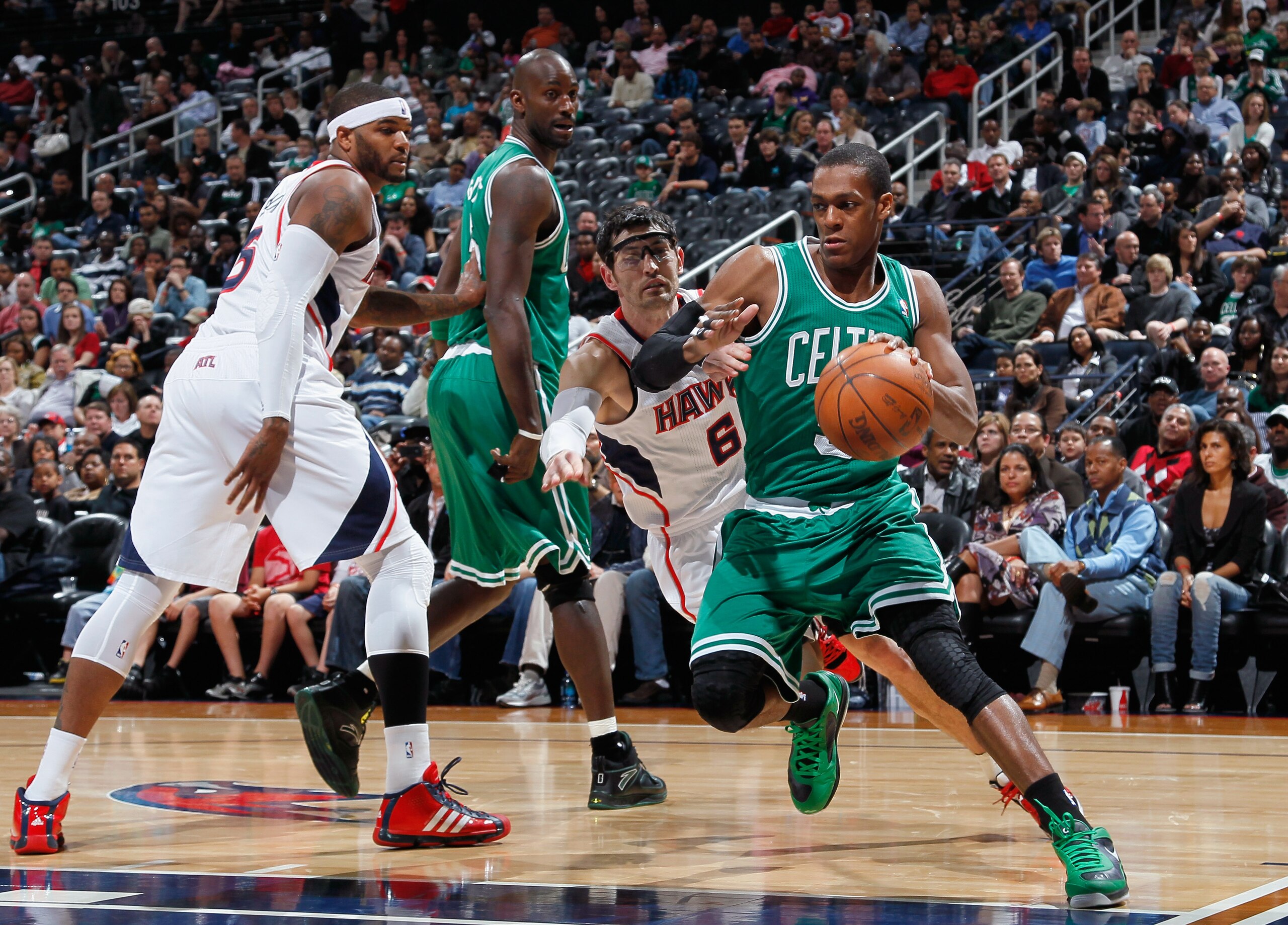 ATLANTA, GA - APRIL 01:  Rajon Rondo #9 of the Boston Celtics against Kirk Hinrich #6 of the Atlanta Hawks at Philips Arena on April 1, 2011 in Atlanta, Georgia.  NOTE TO USER: User expressly acknowledges and agrees that, by downloading and/or using this