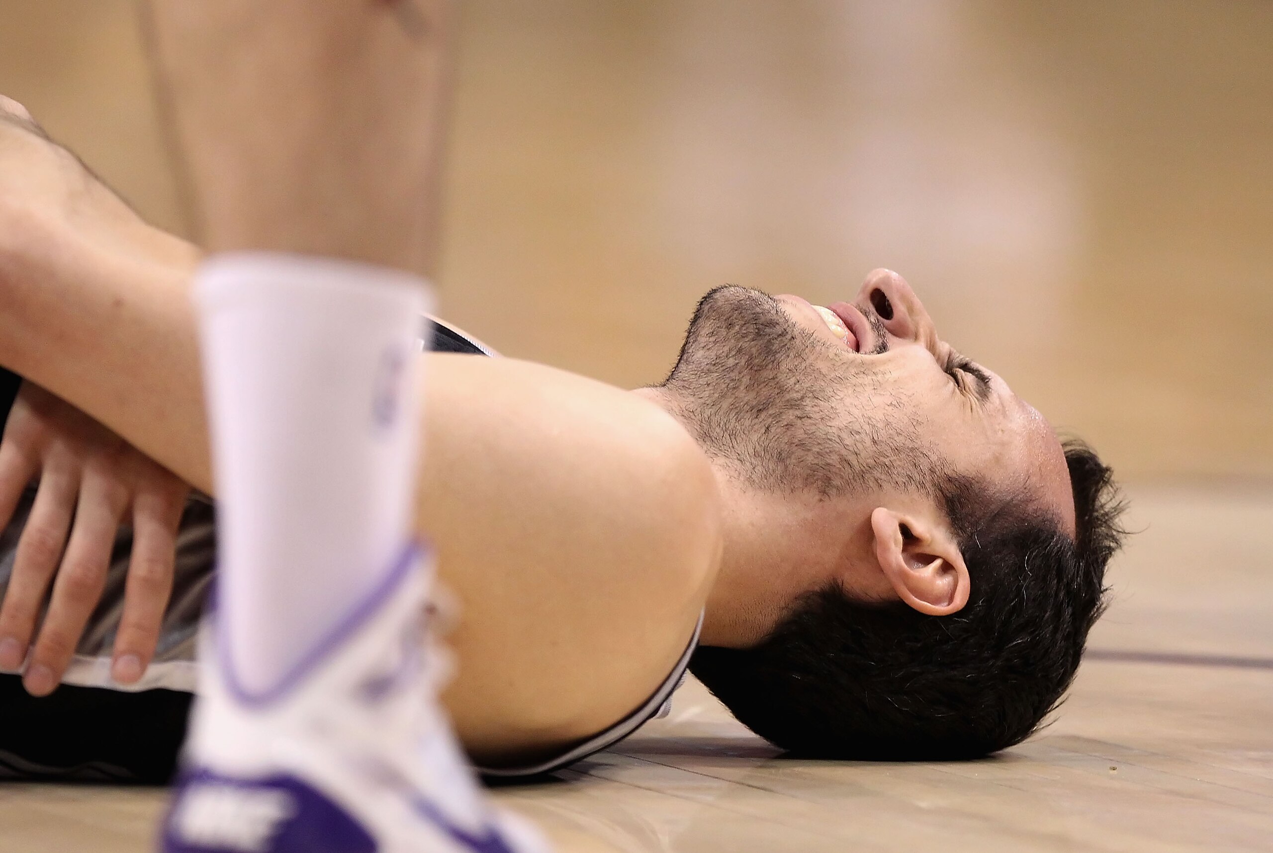 PHOENIX, AZ - APRIL 13:  Manu Ginobili #20 of the San Antonio Spurs reacts after an injury in the NBA game against the Phoenix Suns at US Airways Center on April 13, 2011 in Phoenix, Arizona.  NOTE TO USER: User expressly acknowledges and agrees that, by