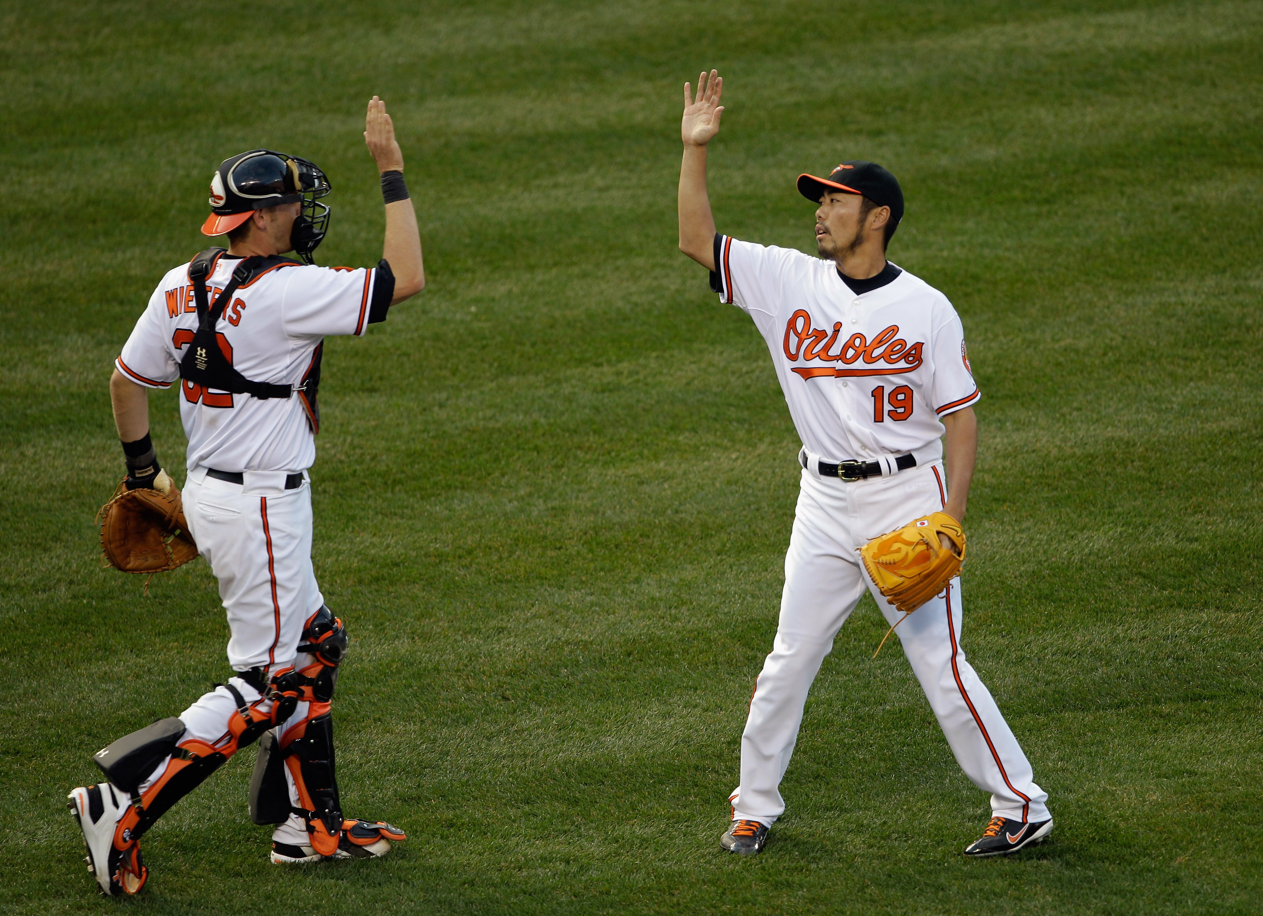 BALTIMORE, MD - APRIL 04: Catcher Matt Wieters #32 of the Baltimore Orioles and reliever Koji Uehara #19 celebrate after the Orioles defeated the Detroit Tigers 5-1 during opening day at Oriole Park at Camden Yards on April 4, 2011 in Baltimore, Maryland.