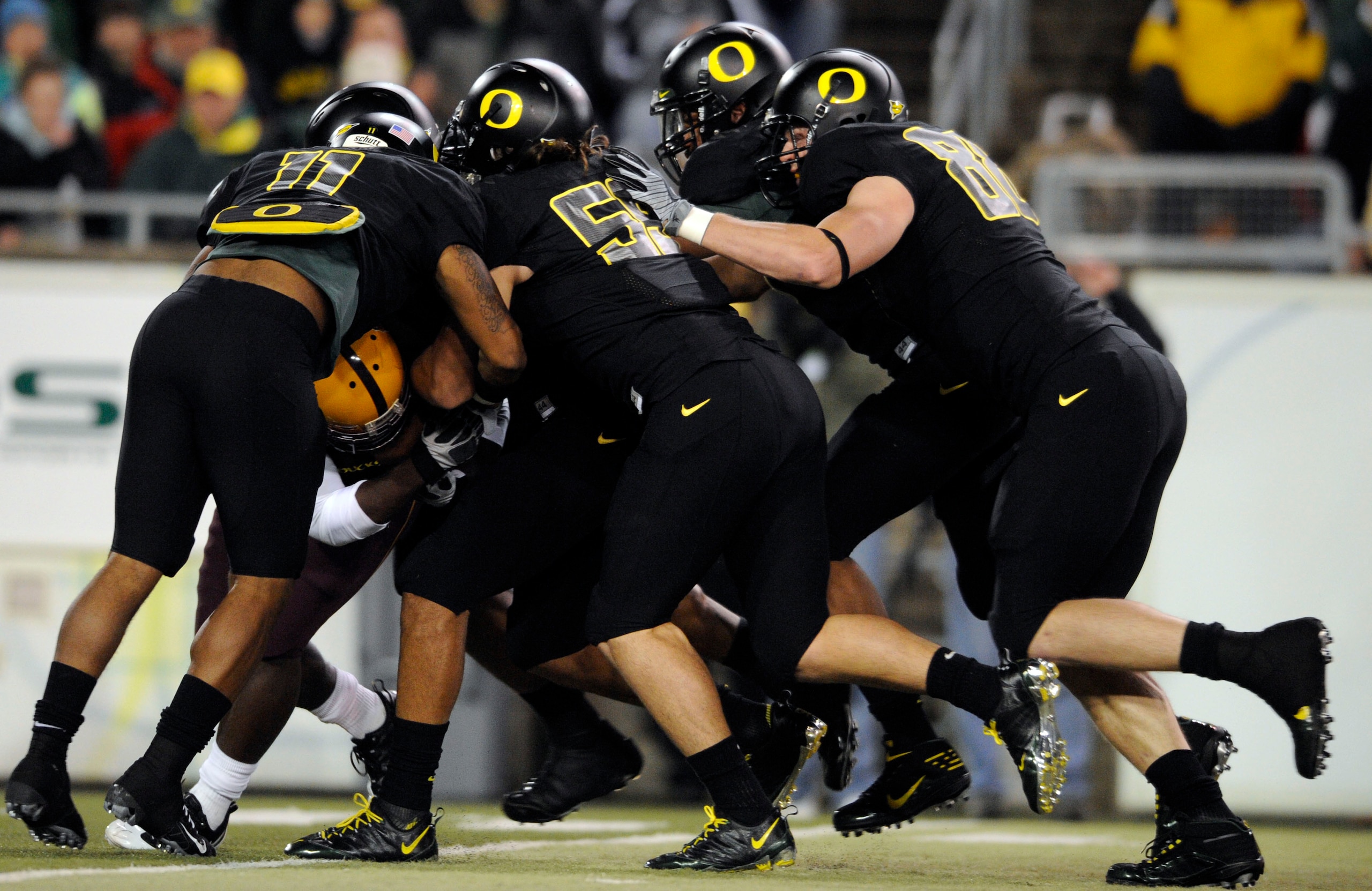 EUGENE,OR - NOVEMBER 14: Linebacker Eddie Pleasant #11, linebacker Casey Matthews #55 and defensive tackle Brandon Bair #88 of the Oregon Ducks gang up to tackle running back Dimitri Nance #31of the Arizona State Sun Devils in the first quarter of the gam EUGENE,OR - NOVEMBER 14: Linebacker Eddie Pleasant #11, linebacker Casey Matthews #55 and defensive tackle Brandon Bair #88 of the Oregon Ducks gang up to tackle running back Dimitri Nance #31of the Arizona State Sun Devils in the first quarter of the gam