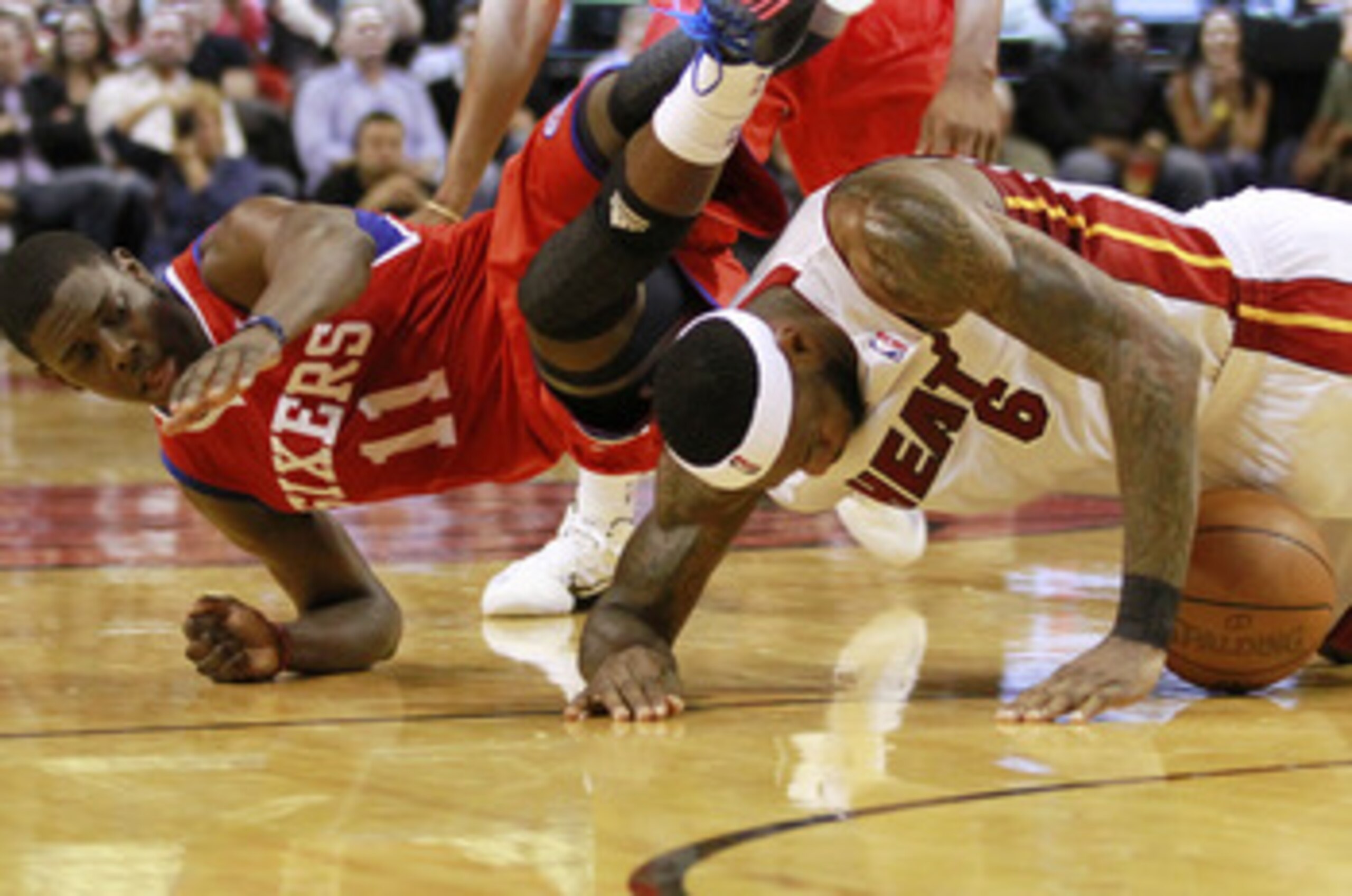 MIAMI, FL - MARCH 25: Forward LeBron James #6 of the Miami Heat battles for the ball with Guard Jrue Holiday #11 of the Philadelphia Sixers at American Airlines Arena on March 25, 2011 in Miami, Florida. NOTE TO USER: User expressly acknowledges and agre MIAMI, FL - MARCH 25: Forward LeBron James #6 of the Miami Heat battles for the ball with Guard Jrue Holiday #11 of the Philadelphia Sixers at American Airlines Arena on March 25, 2011 in Miami, Florida. NOTE TO USER: User expressly acknowledges and agre