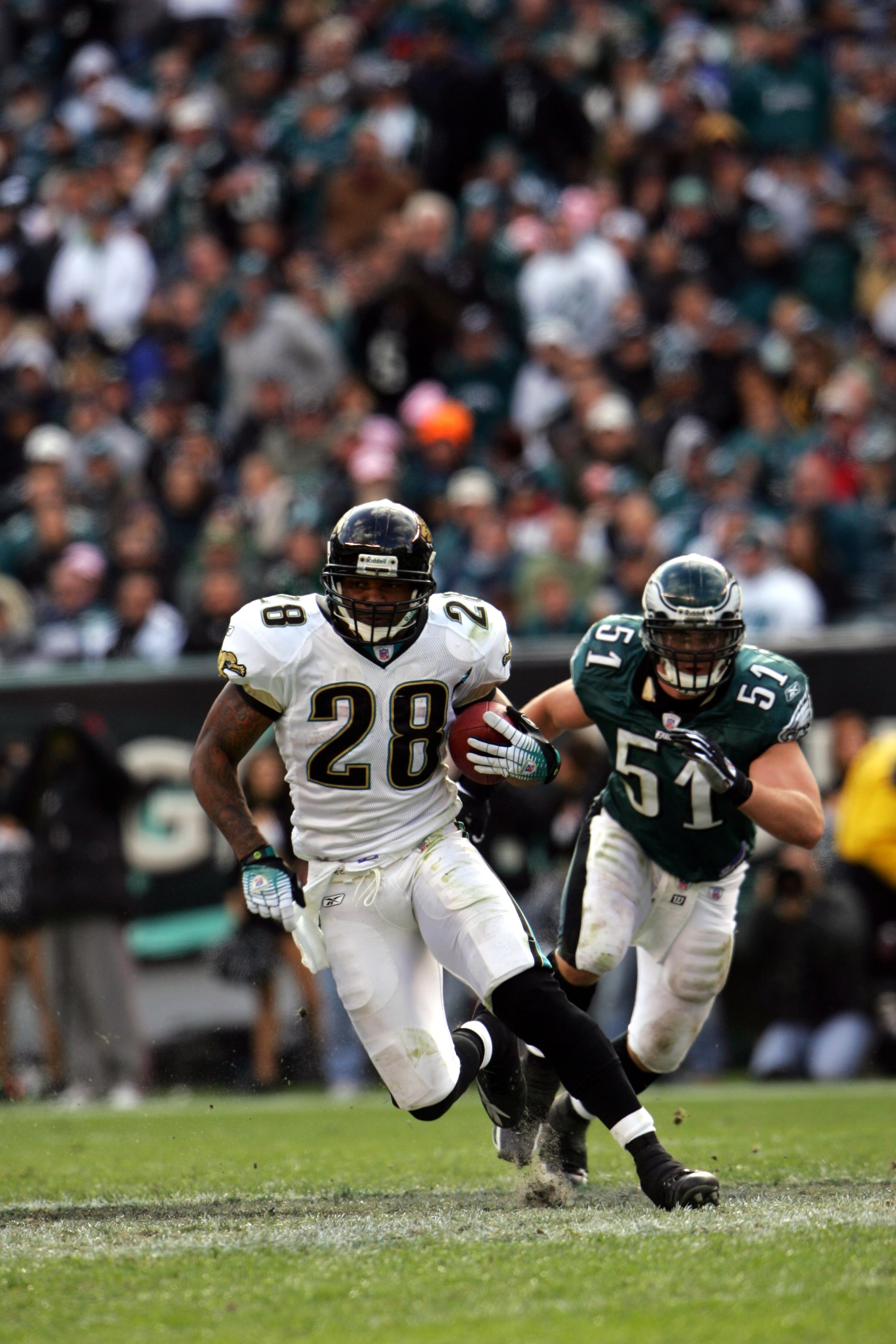 PHILADELPHIA - OCTOBER 29:  Running back Fred Taylor #28 of the Jacksonville Jaguars evades linebacker Matt McCoy #51 of the Philadelphia Eagles during the game on October 29, 2006 at Lincoln Financial Field in Philadelphia, Pennsylvania.  The Jaguars won