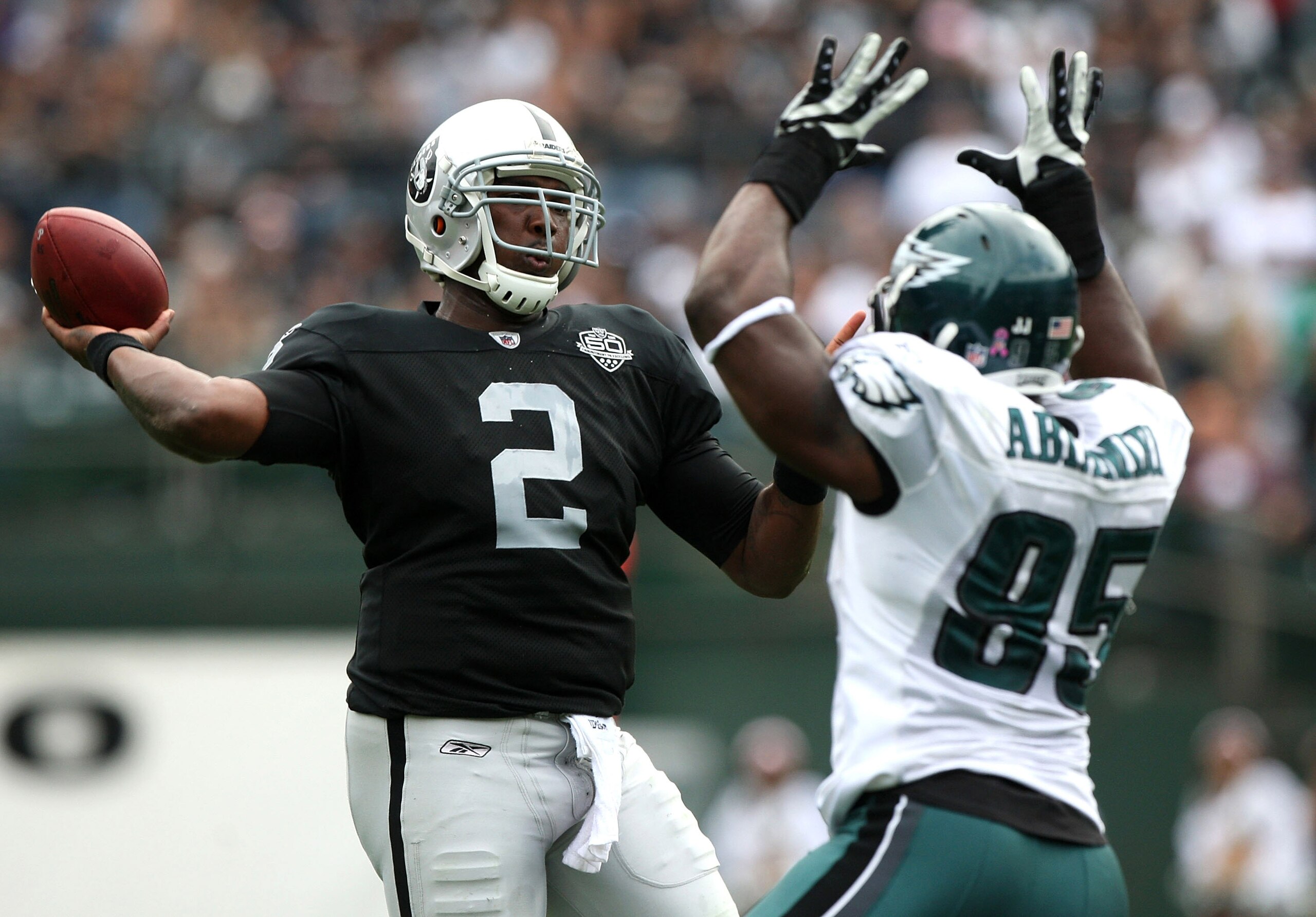 OAKLAND, CA - OCTOBER 18:   JaMarcus Russell #2 of the Oakland Raiders passes against Victor Abiamiri #95 of the Philadelphia Eagles during an NFL game at the Oakland-Alameda County Coliseum on October 18, 2009 in Oakland, California. (Photo by Jed Jacobs