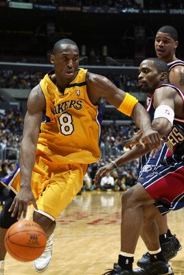 LOS ANGELES - FEBRUARY 18:  Kobe Bryant #8 of the Los Angeles Lakers drives past Cuttino Mobley #5 of the Houston Rockets during the game at Staples Center on February 18, 2003 in Los Angeles, California.  The Lakers won in double overtime 106-99.  NOTE T