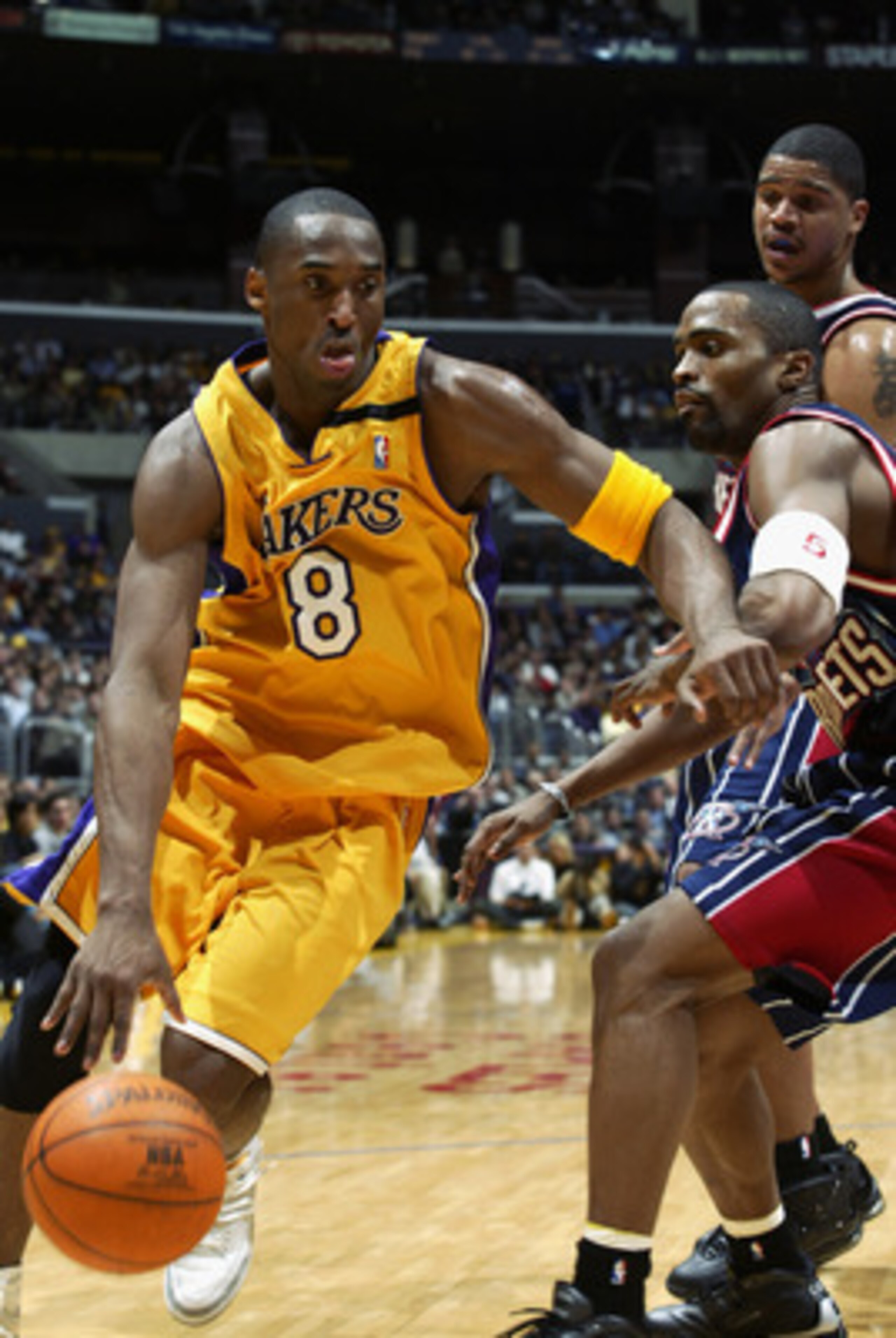 LOS ANGELES - FEBRUARY 18: Kobe Bryant #8 of the Los Angeles Lakers drives past Cuttino Mobley #5 of the Houston Rockets during the game at Staples Center on February 18, 2003 in Los Angeles, California. The Lakers won in double overtime 106-99. NOTE T LOS ANGELES - FEBRUARY 18: Kobe Bryant #8 of the Los Angeles Lakers drives past Cuttino Mobley #5 of the Houston Rockets during the game at Staples Center on February 18, 2003 in Los Angeles, California. The Lakers won in double overtime 106-99. NOTE T