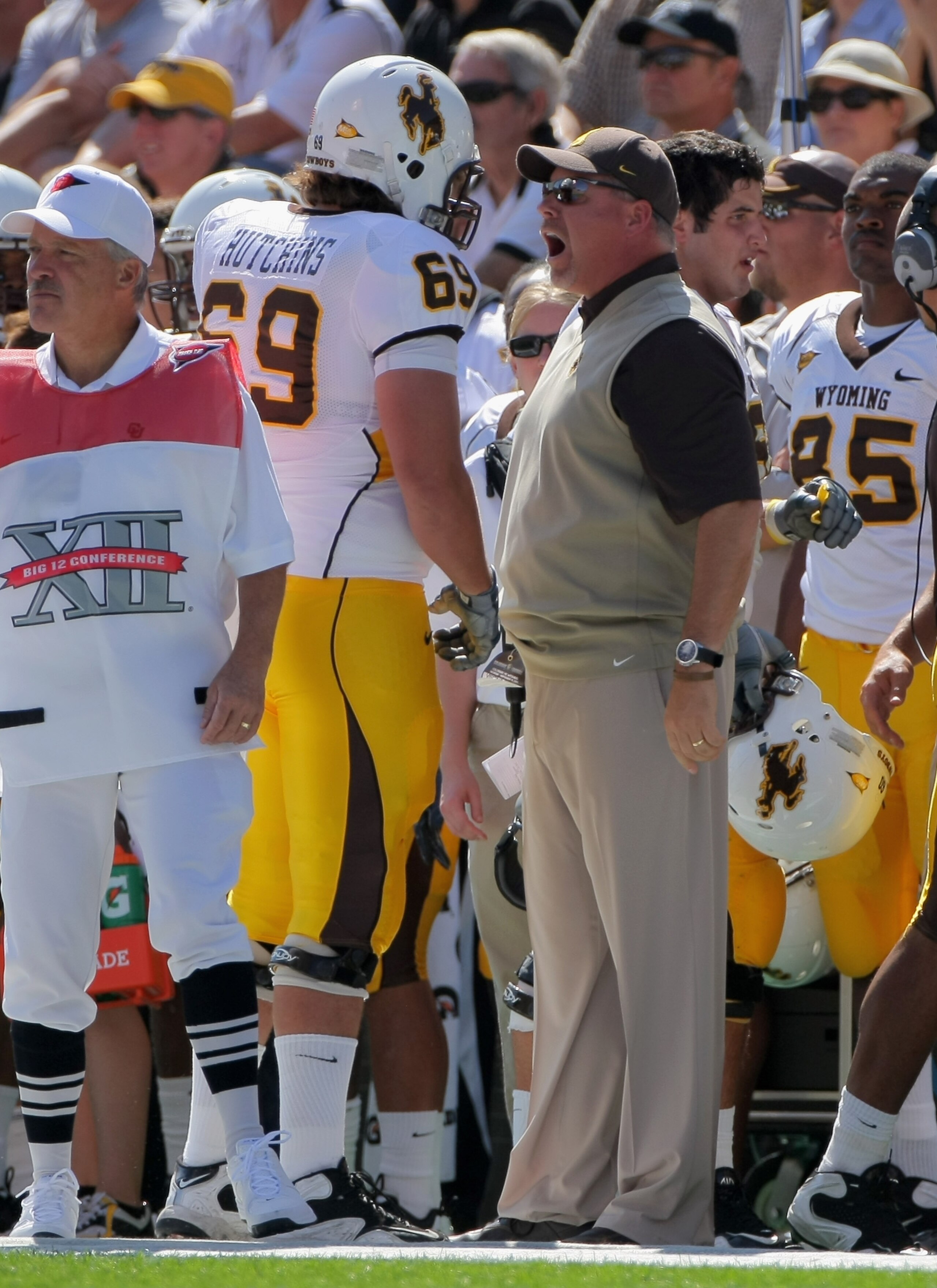 BOULDER, CO - SEPTEMBER 19:  Head coach Dave Christensen of the Wyoming Cowboys has words with right tackle John Hutchins #69 after he was called for illegal motion against the Colorado Buffaloes at Folsom Field on September 19, 2009 in Boulder, Colorado.