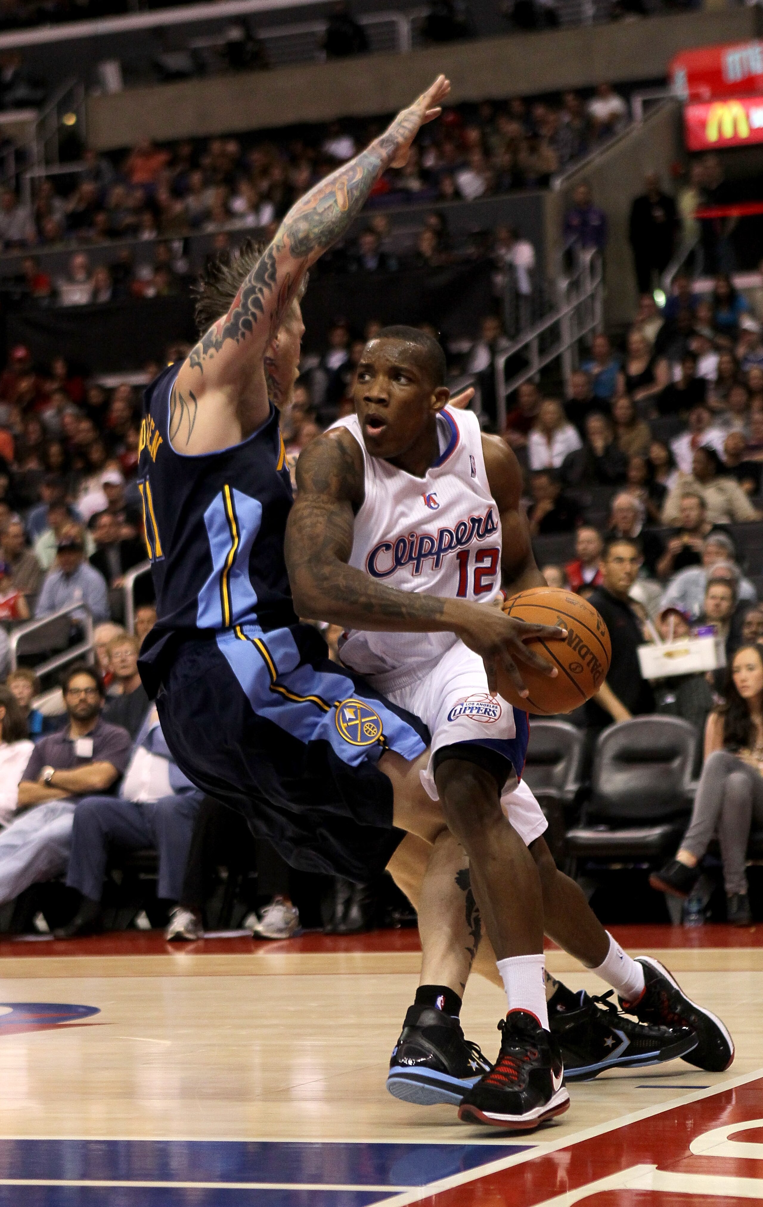 LOS ANGELES, CA - MARCH 5: Eric Bledsoe #12 of the Los Angeles Clippers drives against Chris Andersen #11 of the Denver Nuggets at Staples Center on March 5, 2011 in Los Angeles, California.  The Clippers won 100-94. NOTE TO USER: User expressly acknowled