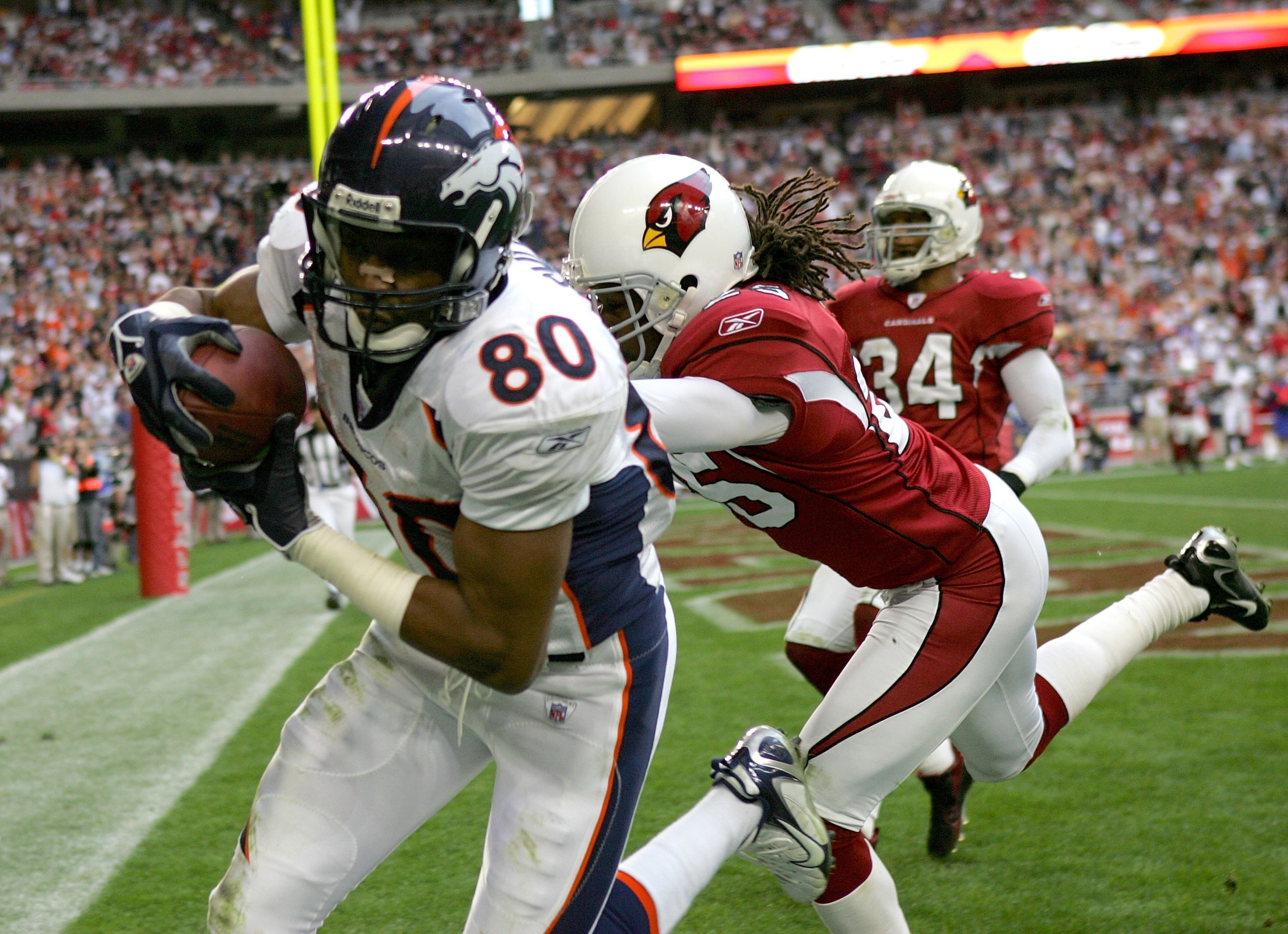 GLENDALE, AZ - DECEMBER 17:   Wide receiver Rod Smith #80 of the Denver Broncos makes a touchdown catch in front of Eric Green #25 of the Arizona Cardinals on December 17, 2006 at University of Phoenix Stadium in Glendale, Arizona.  The Broncos won 37-20.