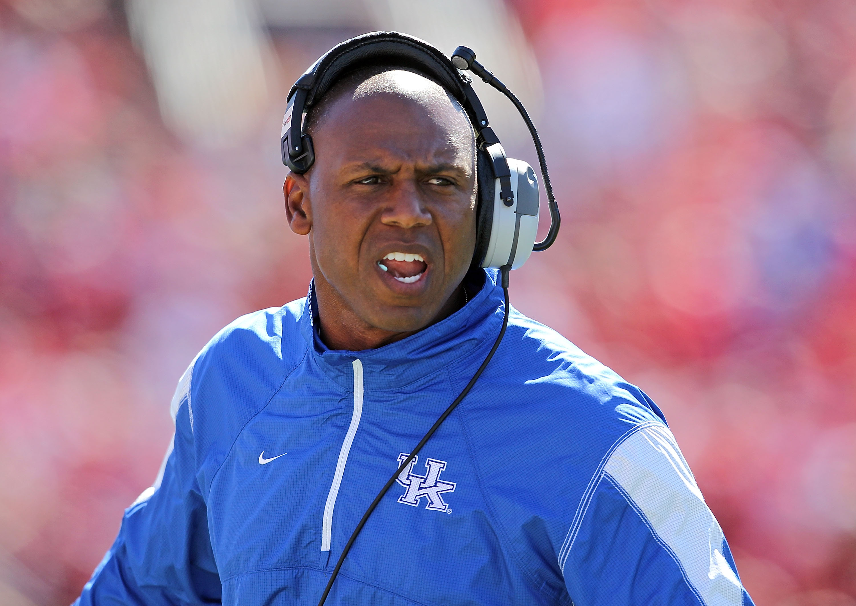LOUISVILLE, KY - SEPTEMBER 04: Joker Phillips the Head Coach of the Kentucky Wildcats gives instructions to his team during the game against the Louisville Cardinals at Papa John's Cardinal Stadium on September 4, 2010 in Louisville, Kentucky.  (Photo by