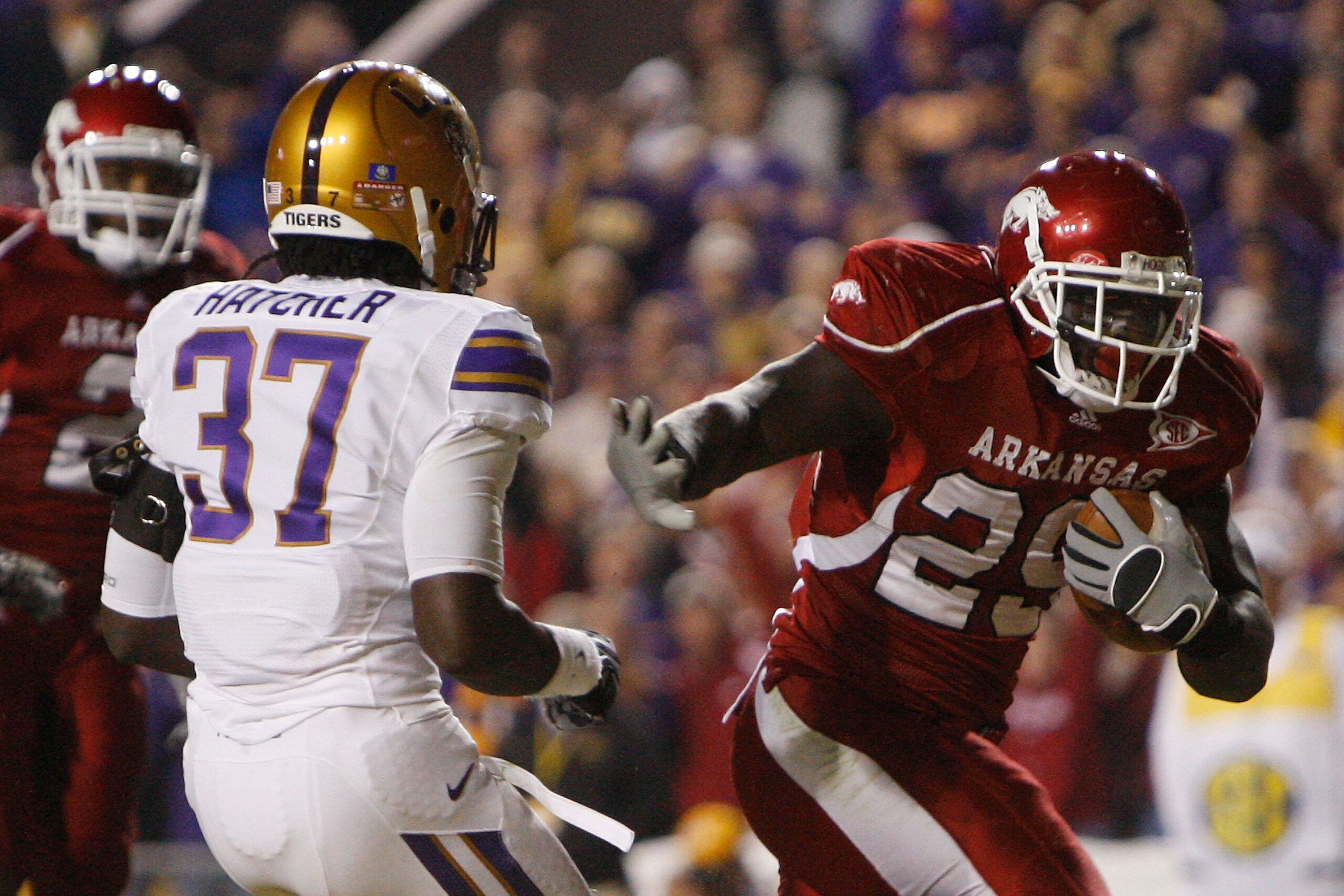BATON ROUGE, LA - NOVEMBER 28: Broderick Green #29 of the Arkansas Razorbacks scores a touchdown around Karnell Hatcher #37 of the LSU Tigers at Tiger Stadium on November 28, 2009 in Baton Rouge, Louisiana. The Tigers defeated the Razorbacks 33-30 in ov BATON ROUGE, LA - NOVEMBER 28: Broderick Green #29 of the Arkansas Razorbacks scores a touchdown around Karnell Hatcher #37 of the LSU Tigers at Tiger Stadium on November 28, 2009 in Baton Rouge, Louisiana. The Tigers defeated the Razorbacks 33-30 in ov