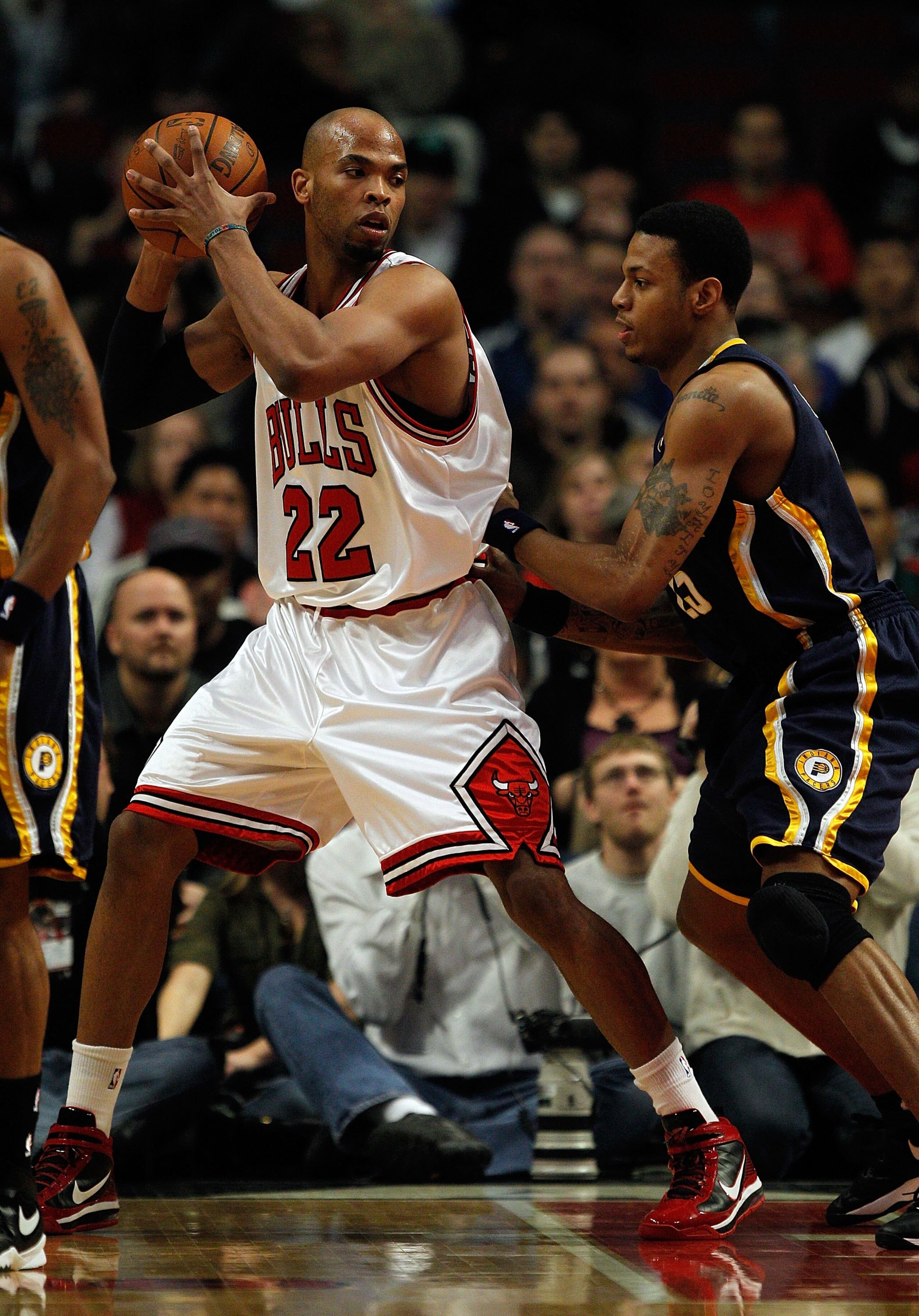 CHICAGO - FEBRUARY 24: Taj Gibson #22 of the Chicago Bulls looks to move against Brandon Rush #25 of the Indiana Pacers at the United Center on February 24, 2010 in Chicago, Illinois. The Bulls defeated the Pacers 120-110. NOTE TO USER: User expressly ack CHICAGO - FEBRUARY 24: Taj Gibson #22 of the Chicago Bulls looks to move against Brandon Rush #25 of the Indiana Pacers at the United Center on February 24, 2010 in Chicago, Illinois. The Bulls defeated the Pacers 120-110. NOTE TO USER: User expressly ack