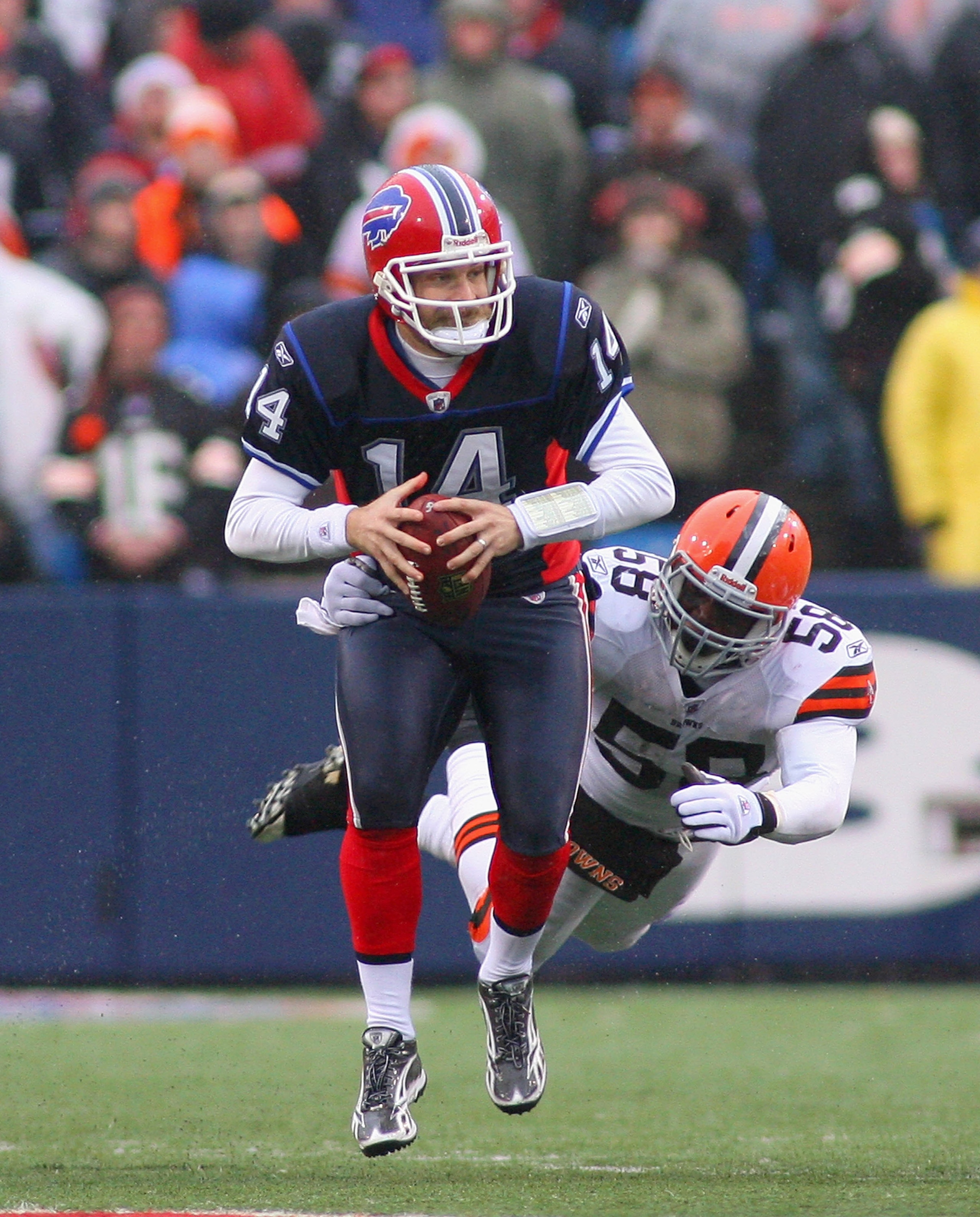 ORCHARD PARK, NY - DECEMBER 12: Ryan Fitzpatrick #14 of the Buffalo Bills looks to pass with pressure from Marcus Benard #58 of the Cleveland Browns at Ralph Wilson Stadium on December 12, 2010 in Orchard Park, New York. Buffalo won 13-6. (Photo by Rick ORCHARD PARK, NY - DECEMBER 12: Ryan Fitzpatrick #14 of the Buffalo Bills looks to pass with pressure from Marcus Benard #58 of the Cleveland Browns at Ralph Wilson Stadium on December 12, 2010 in Orchard Park, New York. Buffalo won 13-6. (Photo by Rick