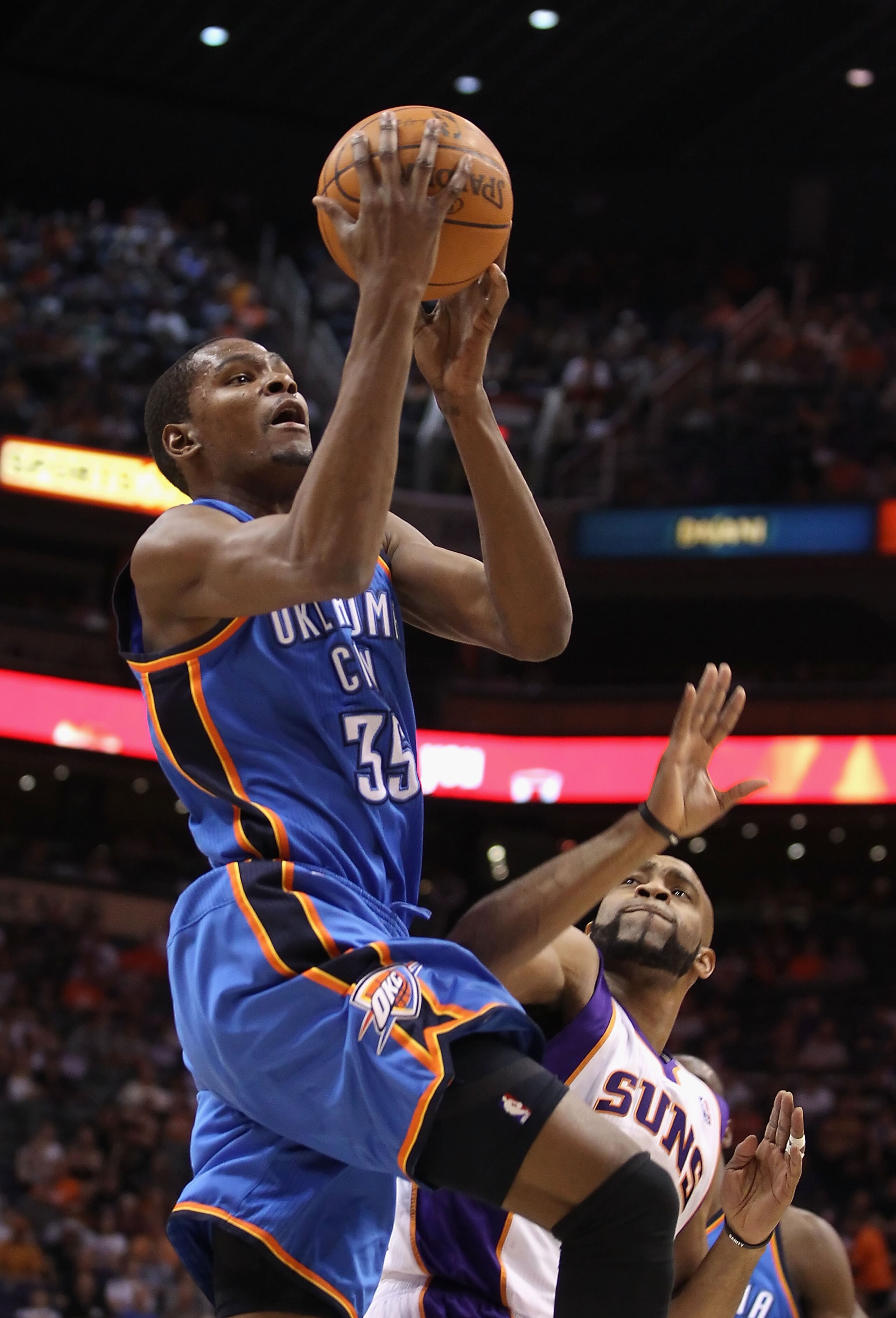 PHOENIX, AZ - MARCH 30:  Kevin Durant #35 of the Oklahoma City Thunder puts up a shot over Vince Carter #25 of the Phoenix Suns during the NBA game at US Airways Center on March 30, 2011 in Phoenix, Arizona.  NOTE TO USER: User expressly acknowledges and