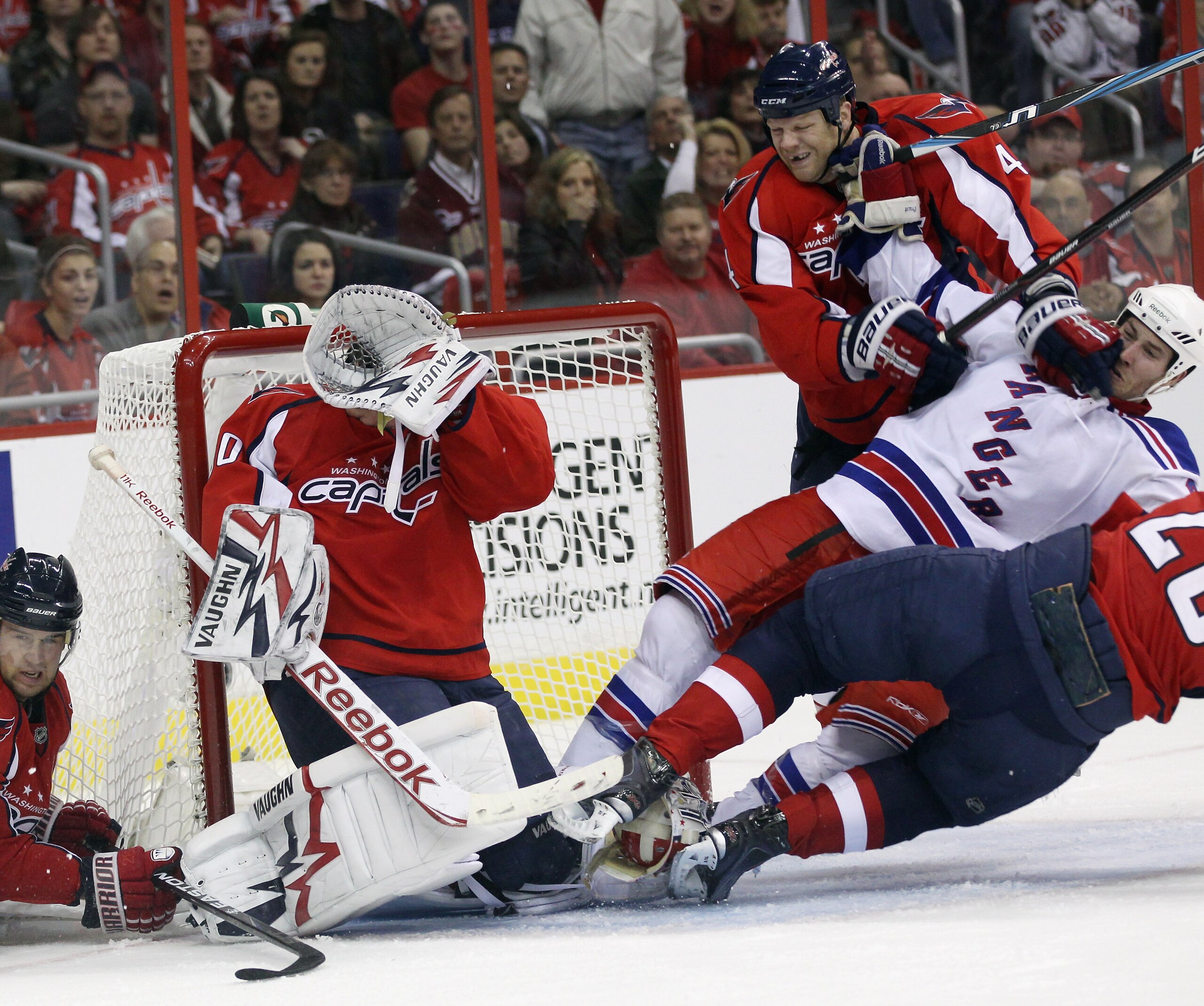 WASHINGTON, DC - APRIL 13: John Erskine #4 of the Washington Capitals skates against Brandon Prust #8 of the New York Rangers in Game One of the Eastern Conference Quarterfinals during the 2011 NHL Stanley Cup Playoffs at Verizon Center on April 13, 2011