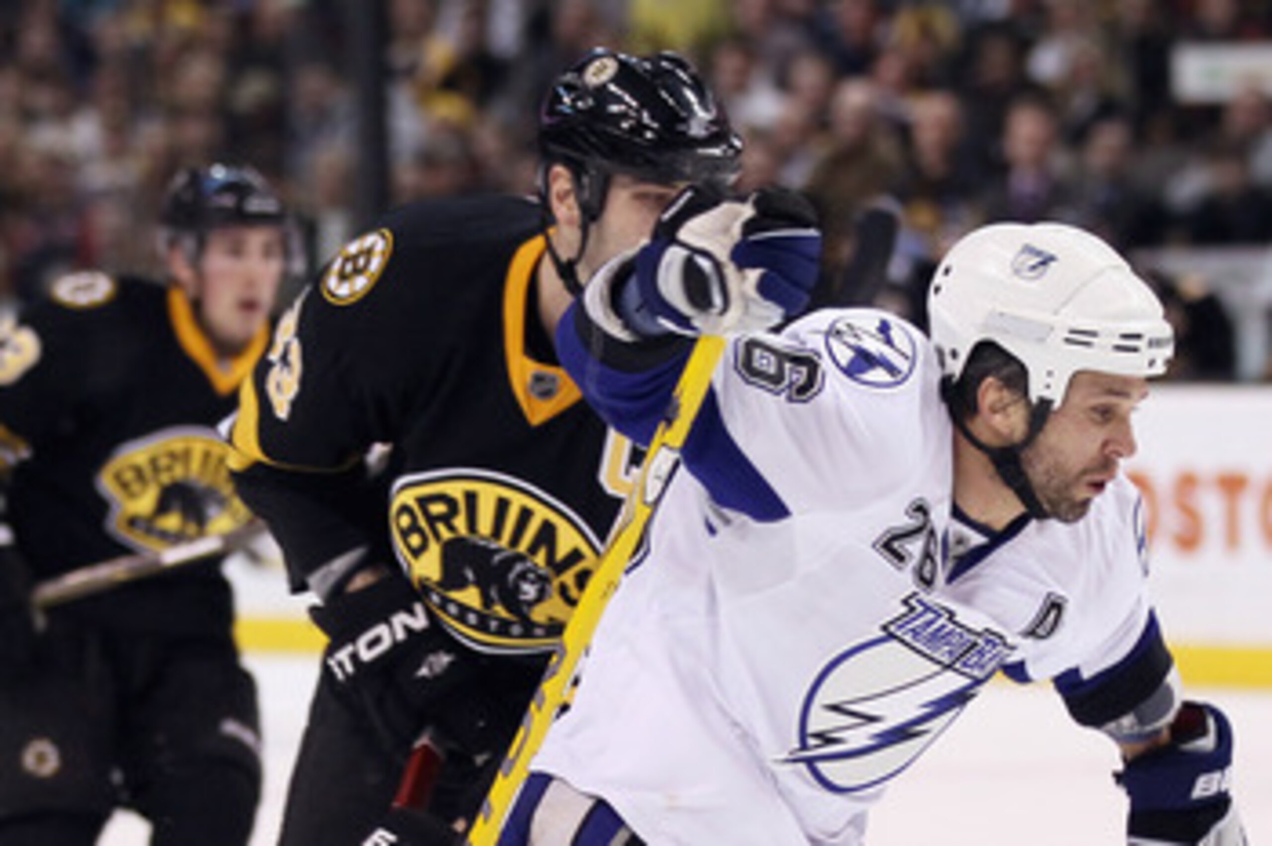 BOSTON, MA - MARCH 03:  Martin St. Louis #26 of the Tampa Bay Lightning is tripped up by Zdeno Chara #33 of the Boston Bruins on March 3, 2011 at the TD Garden in Boston, Massachusetts.  (Photo by Elsa/Getty Images)