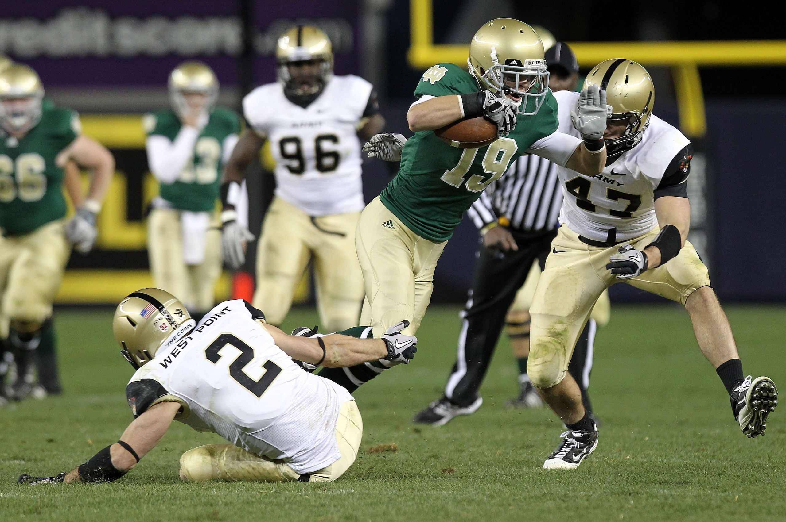 NEW YORK - NOVEMBER 20: Robby Toma #19 of the Notre Dame Fighting Irish is tackled by Richard King #2 and Bill Prosko #47 of the Army Black Knights at Yankee Stadium on November 20, 2010 in the Bronx borough of New York City. (Photo by Nick Laham/Getty I NEW YORK - NOVEMBER 20: Robby Toma #19 of the Notre Dame Fighting Irish is tackled by Richard King #2 and Bill Prosko #47 of the Army Black Knights at Yankee Stadium on November 20, 2010 in the Bronx borough of New York City. (Photo by Nick Laham/Getty I