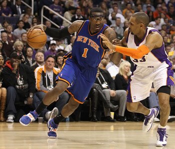 PHOENIX, AZ - JANUARY 07:  Amar'e Stoudemire #1 of the New York Knicks drives the ball against Grant Hill #33 of the Phoenix Suns during the NBA game at US Airways Center on January 7, 2011 in Phoenix, Arizona.  NOTE TO USER: User expressly acknowledges a