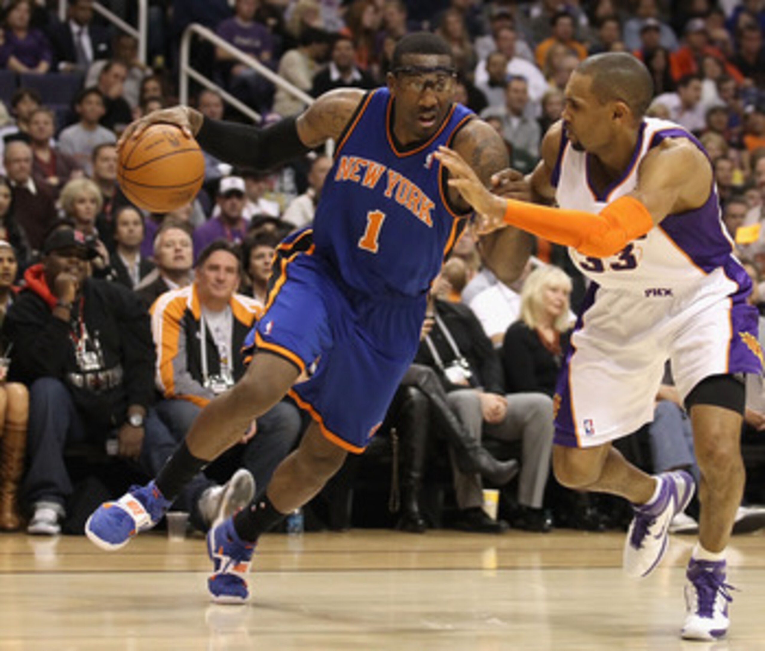 PHOENIX, AZ - JANUARY 07:  Amar'e Stoudemire #1 of the New York Knicks drives the ball against Grant Hill #33 of the Phoenix Suns during the NBA game at US Airways Center on January 7, 2011 in Phoenix, Arizona.  NOTE TO USER: User expressly acknowledges a