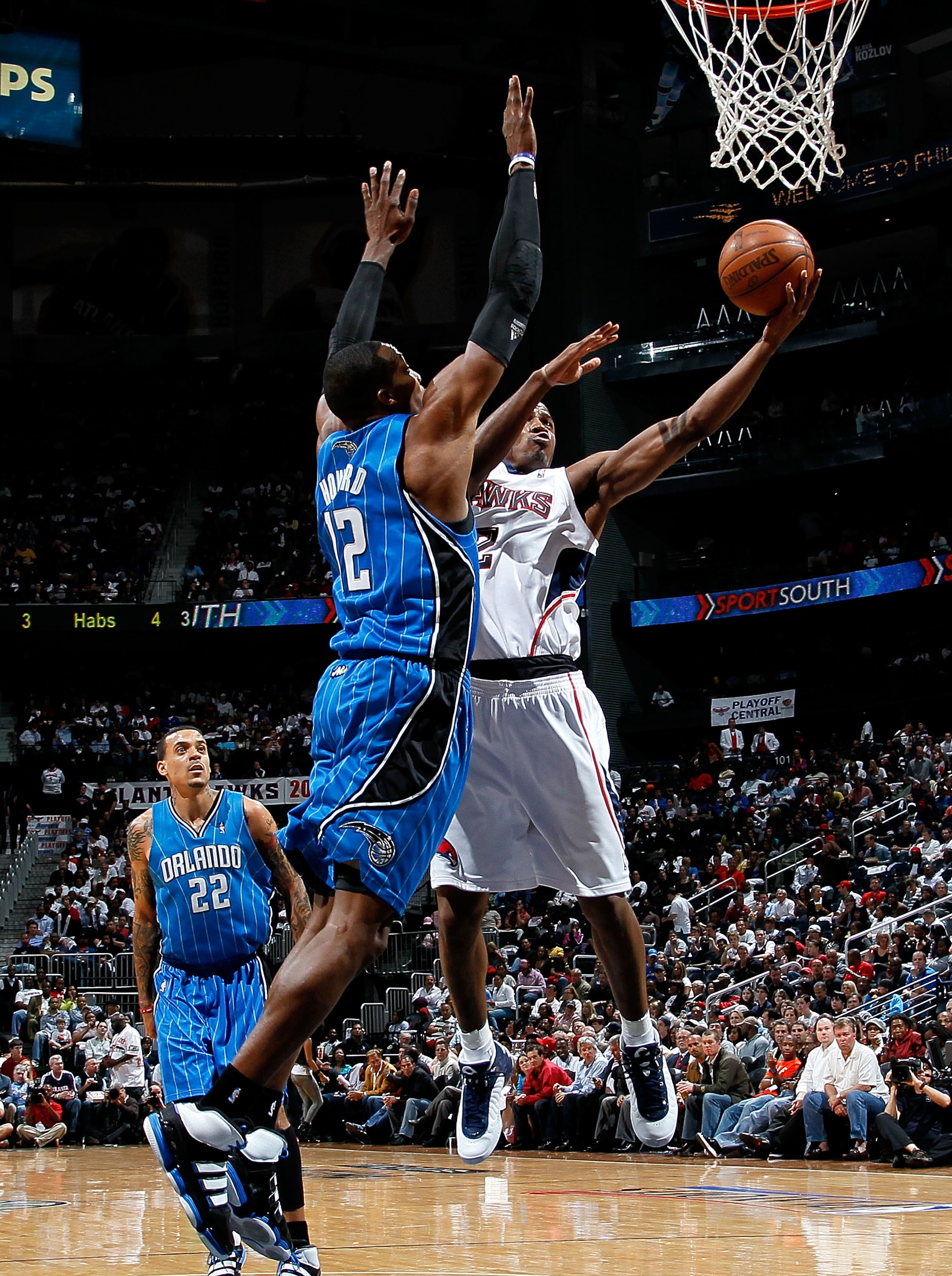 ATLANTA - MAY 10:  Dwight Howard #12 of the Orlando Magic defends the basket against Joe Johnson #2 of the Atlanta Hawks during Game Four of the Eastern Conference Semifinals of the 2010 NBA Playoffs at Philips Arena on May 10, 2010 in Atlanta, Georgia.