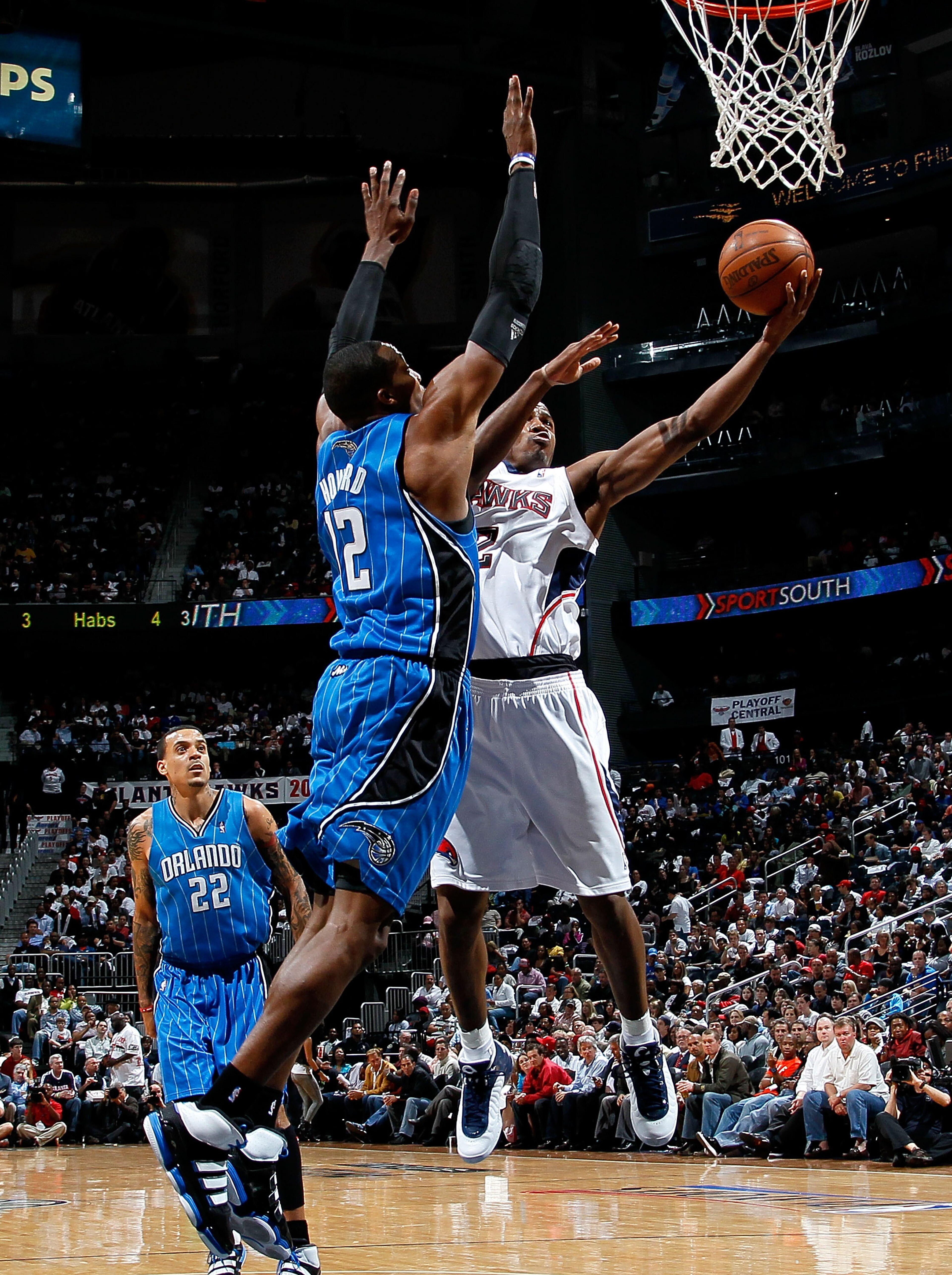 ATLANTA - MAY 10:  Dwight Howard #12 of the Orlando Magic defends the basket against Joe Johnson #2 of the Atlanta Hawks during Game Four of the Eastern Conference Semifinals of the 2010 NBA Playoffs at Philips Arena on May 10, 2010 in Atlanta, Georgia.