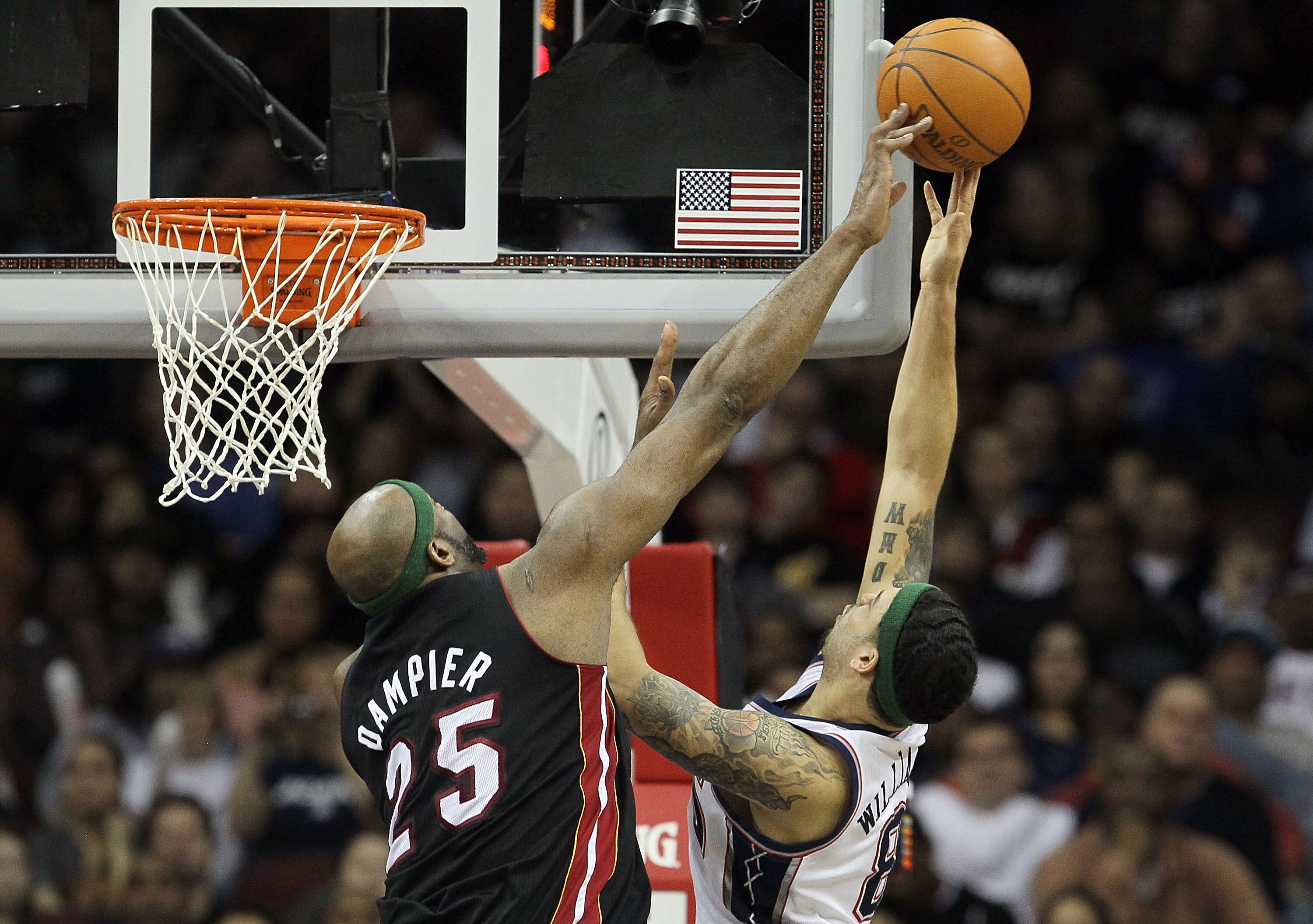 NEWARK, NJ - APRIL 03:  Eric Dampier #25 of the Miami Heat blocks a shot from Deron Williams #8 of the New Jersey Nets at the Prudential Center on April 3, 2011 in Newark, New Jersey.The Heat defeated the Nets 108-94.NOTE TO USER: User expressly acknowled