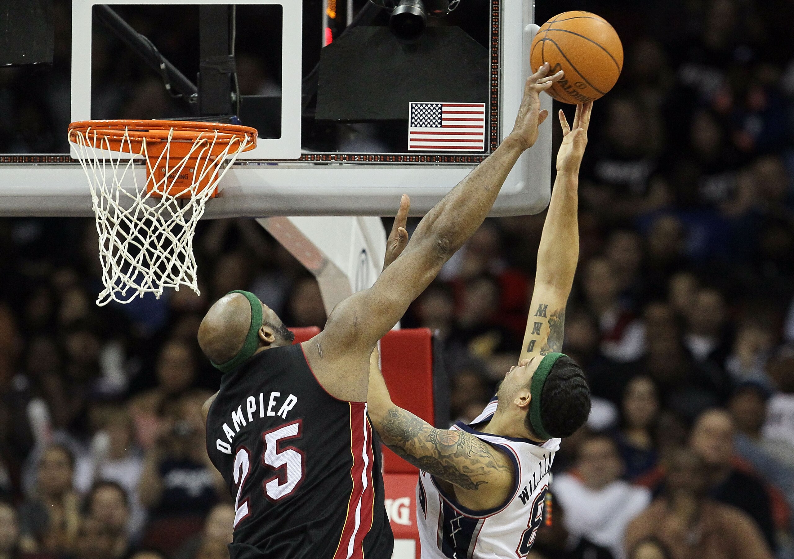 NEWARK, NJ - APRIL 03:  Eric Dampier #25 of the Miami Heat blocks a shot from Deron Williams #8 of the New Jersey Nets at the Prudential Center on April 3, 2011 in Newark, New Jersey.The Heat defeated the Nets 108-94.NOTE TO USER: User expressly acknowled