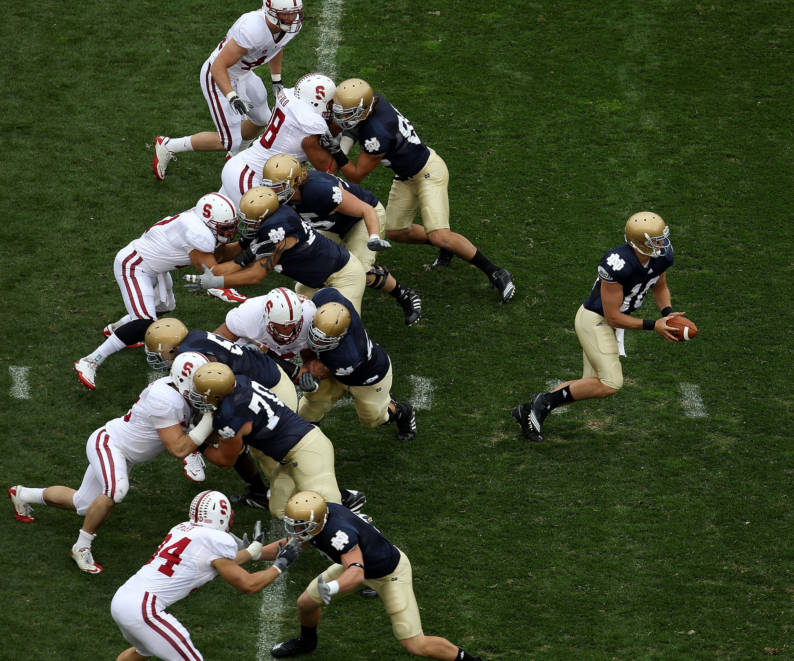 SOUTH BEND, IN - SEPTEMBER 25: Dayne Crist #10 of the Notre Dame Fighting Irish turns to hand-off as his offensive line blocks against the Stanford Cardinal defense at Notre Dame Stadium on September 25, 2010 in South Bend, Indiana. Standford defeated Not SOUTH BEND, IN - SEPTEMBER 25: Dayne Crist #10 of the Notre Dame Fighting Irish turns to hand-off as his offensive line blocks against the Stanford Cardinal defense at Notre Dame Stadium on September 25, 2010 in South Bend, Indiana. Standford defeated Not