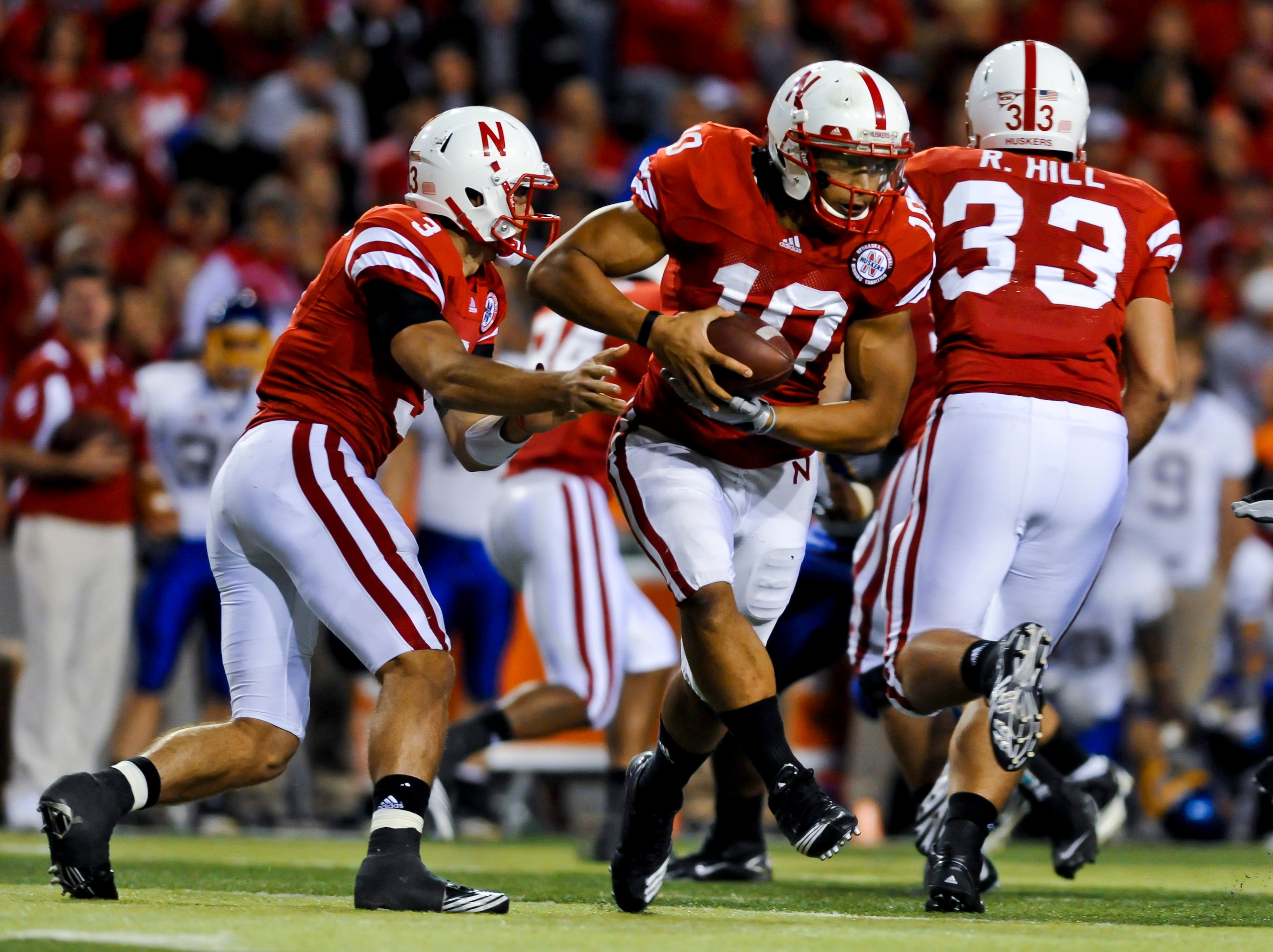 LINCOLN, NEBRASKA - SEPTEMBER 25: Nebraska Cornhuskers quarterback Taylor Martinez #3 hands the ball to running back Roy Helu Jr. #10 during second half action of their game at Memorial Stadium on September 25, 2010 in Lincoln, Nebraska. Nebraska Defeated LINCOLN, NEBRASKA - SEPTEMBER 25: Nebraska Cornhuskers quarterback Taylor Martinez #3 hands the ball to running back Roy Helu Jr. #10 during second half action of their game at Memorial Stadium on September 25, 2010 in Lincoln, Nebraska. Nebraska Defeated