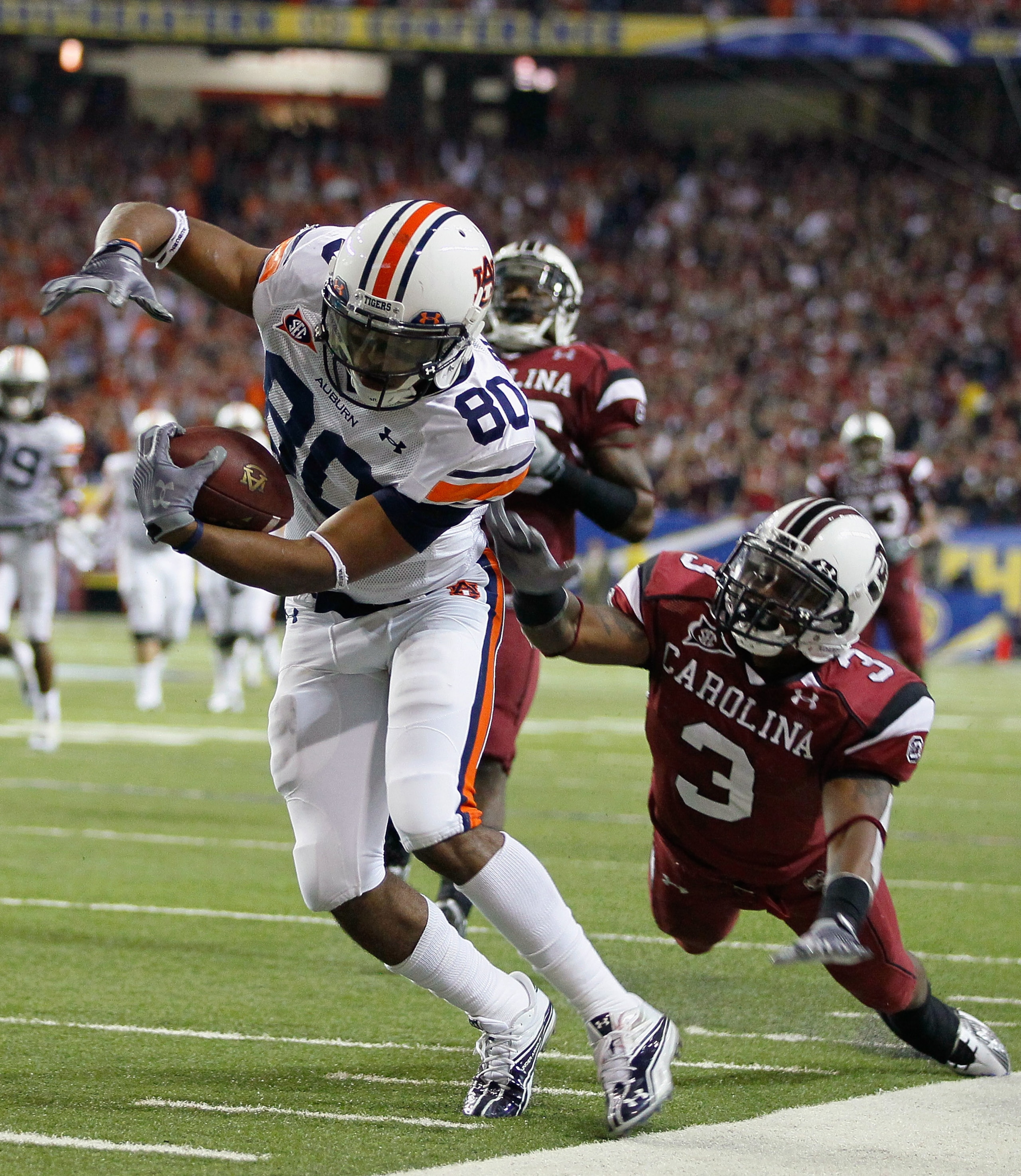 ATLANTA, GA - DECEMBER 04:  Emory Blake #80 of the Auburn Tigers is tackled by Akeem Auguste #3 of the South Carolina Gamecocks during the 2010 SEC Championship at Georgia Dome on December 4, 2010 in Atlanta, Georgia.  (Photo by Kevin C. Cox/Getty Images)