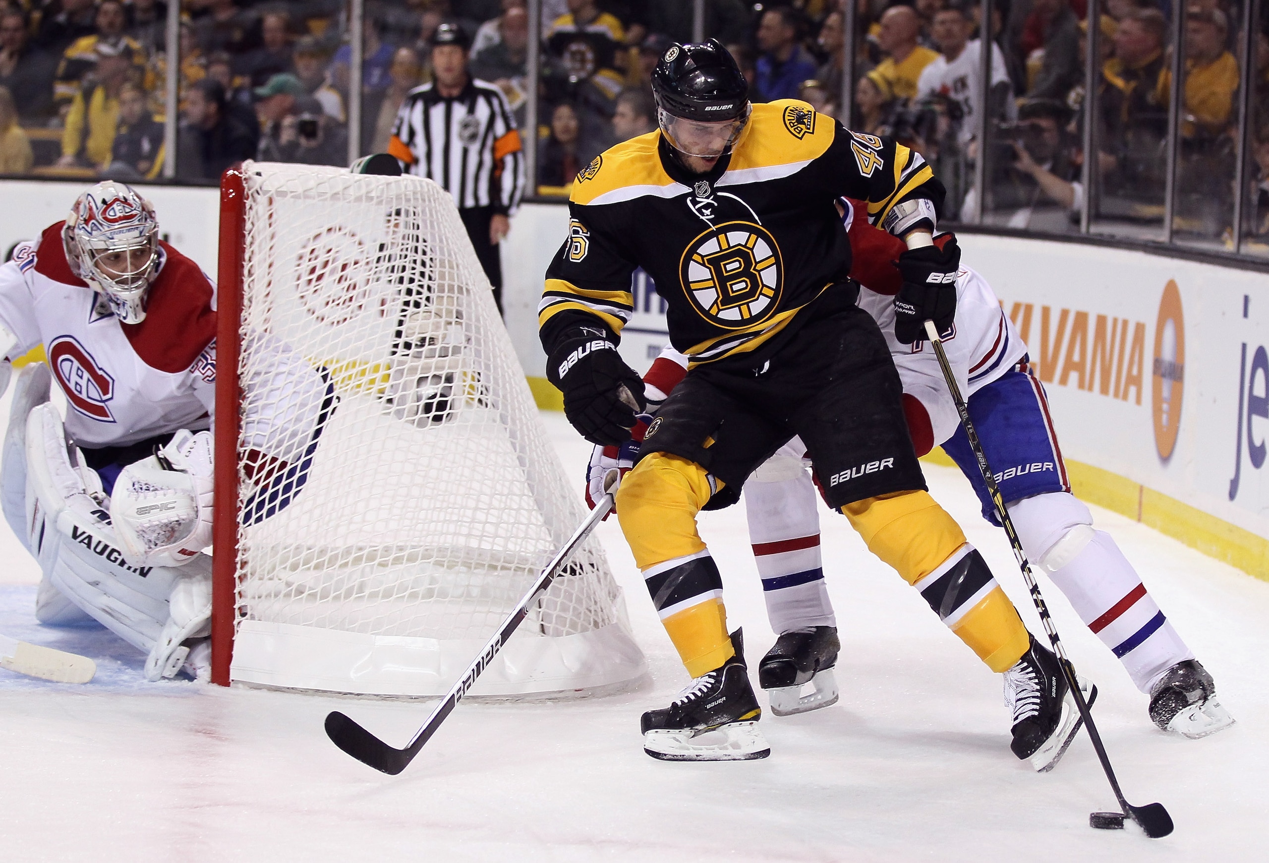 BOSTON, MA - APRIL 14:  David Krejci #46 of the Boston Bruins wraps around the net as Tomas Plekanec #14 and Carey Price #31 of the Montreal Canadiens defend in Game One of the Eastern Conference Quarterfinals during the 2011 NHL Stanley Cup Playoffs at T