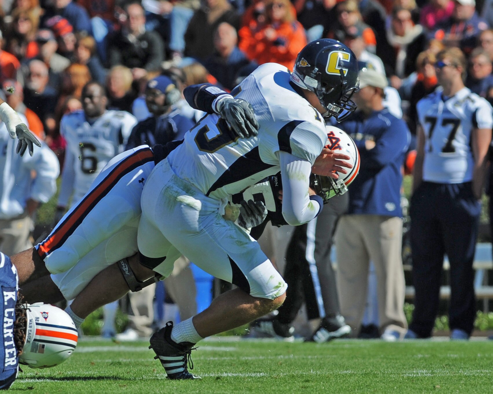 AUBURN, AL - NOVEMBER 06:  Defensive end Corey Lemonier #55 of the Auburn Tigers tackles quarterback B. J. Coleman #19 of  the Chattanooga Mocs November 6, 2010 at Jordan-Hare Stadium in Auburn, Alabama.  (Photo by Al Messerschmidt/Getty Images)