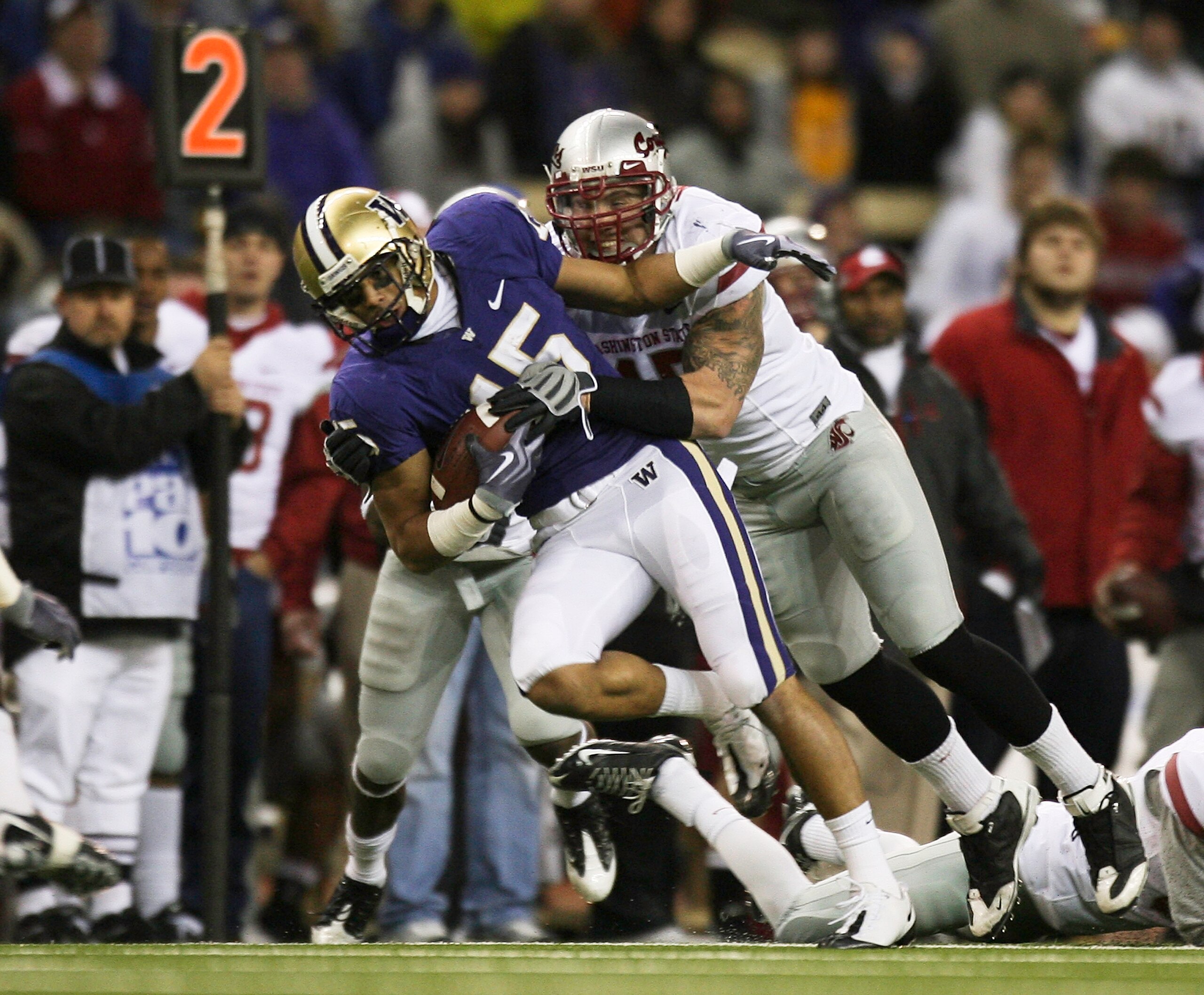 SEATTLE - NOVEMBER 28:  Wide receiver Jermaine Kearse #15 of the Washington Huskies rushes against Andy Mattingly #45 of the Washington State Cougars on November 28, 2009 at Husky Stadium in Seattle, Washington. The Huskies defeated the Cougars 30-0. (Pho
