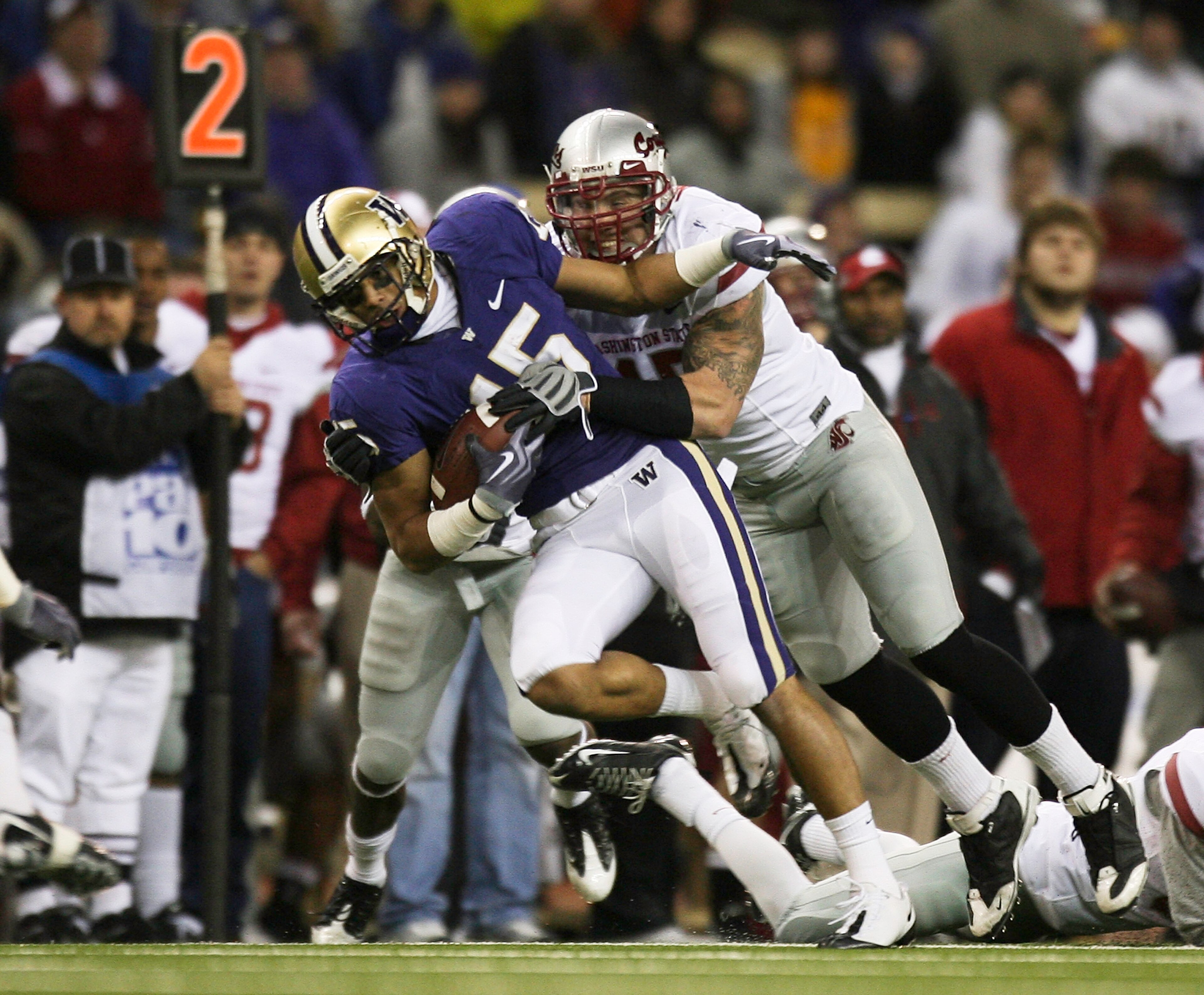 SEATTLE - NOVEMBER 28:  Wide receiver Jermaine Kearse #15 of the Washington Huskies rushes against Andy Mattingly #45 of the Washington State Cougars on November 28, 2009 at Husky Stadium in Seattle, Washington. The Huskies defeated the Cougars 30-0. (Pho