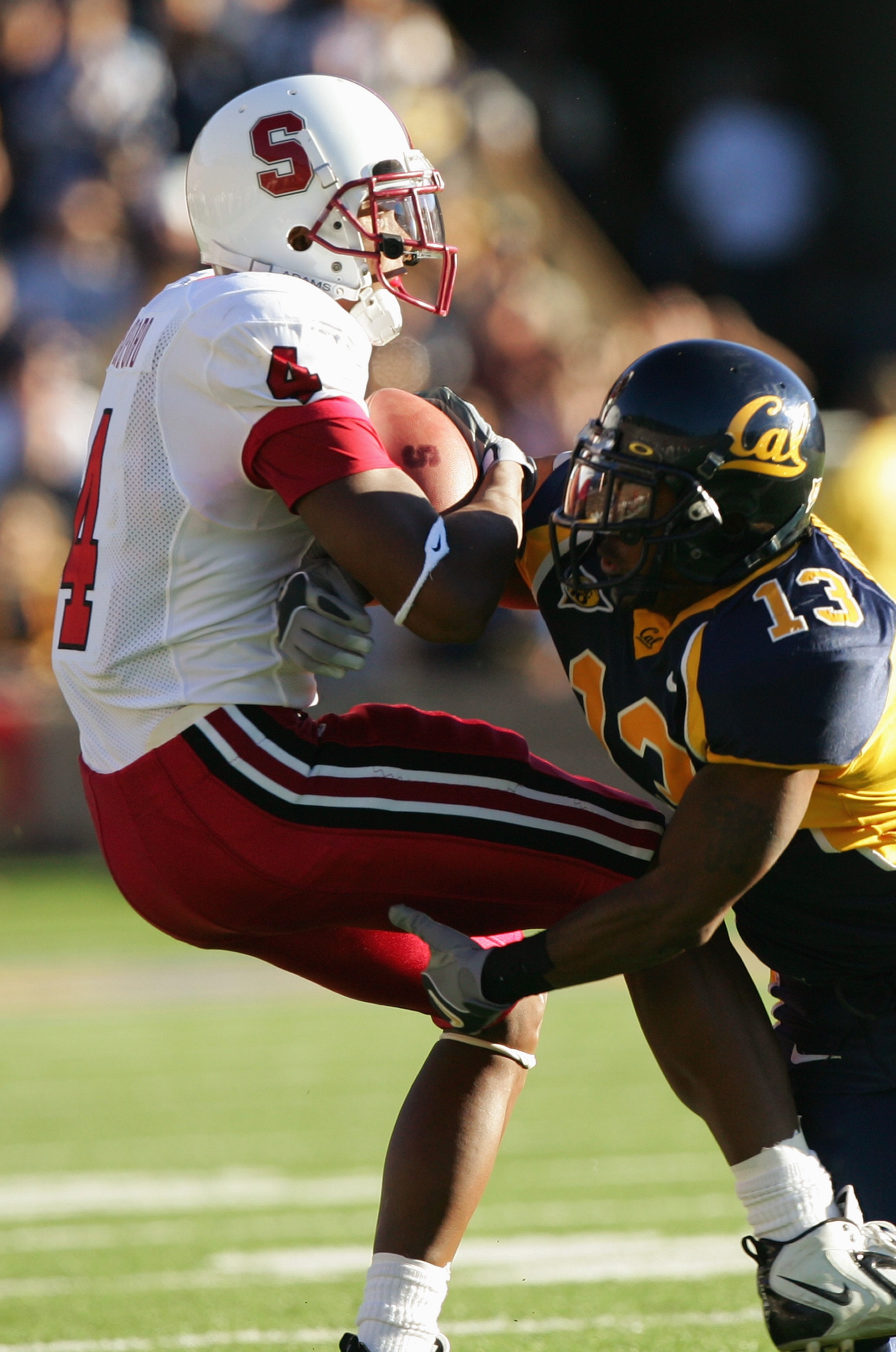 BERKELEY, CA - NOVEMBER 20:  Wide receiver Mark Bradford #4 of the Stanford University Cardinal is tackled by cornerback Daymeion Hughes #13 of the University of California, Berkeley Golden Bears during the game at Memorial Stadium on November 20, 2004 in