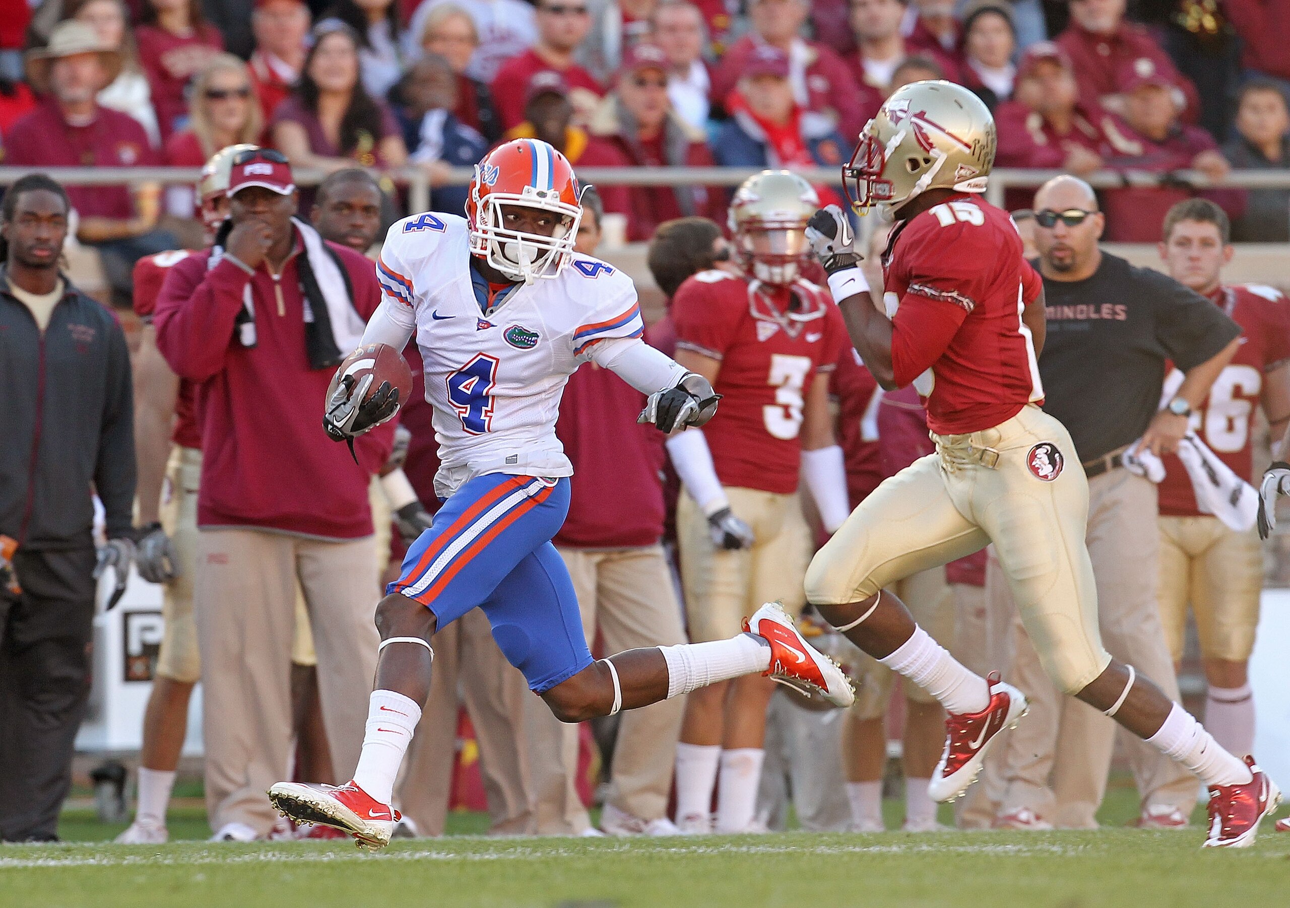 TALLAHASSEE, FL - NOVEMBER 27:  Andre Debose #4 of the Florida Gators rushes after a catch before being forced out of bounds by  Ochuko Jenije #15 of the Florida State Seminoles during a game at Doak Campbell Stadium on November 27, 2010 in Tallahassee, F