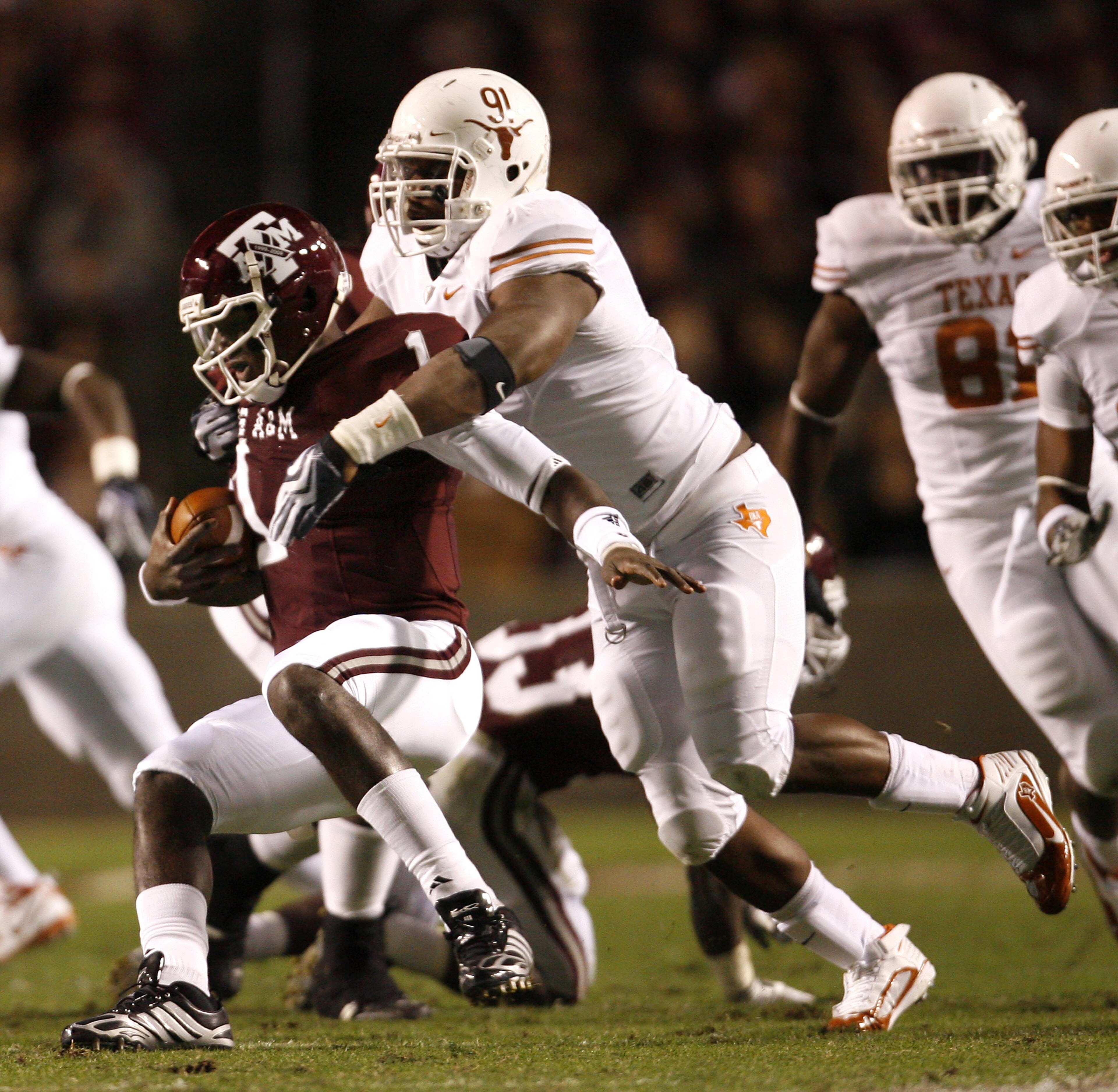 COLLEGE STATION, TX - NOVEMBER 26: Defensive tackle Kheeston Randall #91 of the Texas Longhorns sacks quarterback Jerrod Johnson #1 of the Texas A&M Aggies for a loss in the first half at Kyle Field on November 26, 2009 in College Station, Texas. The Long
