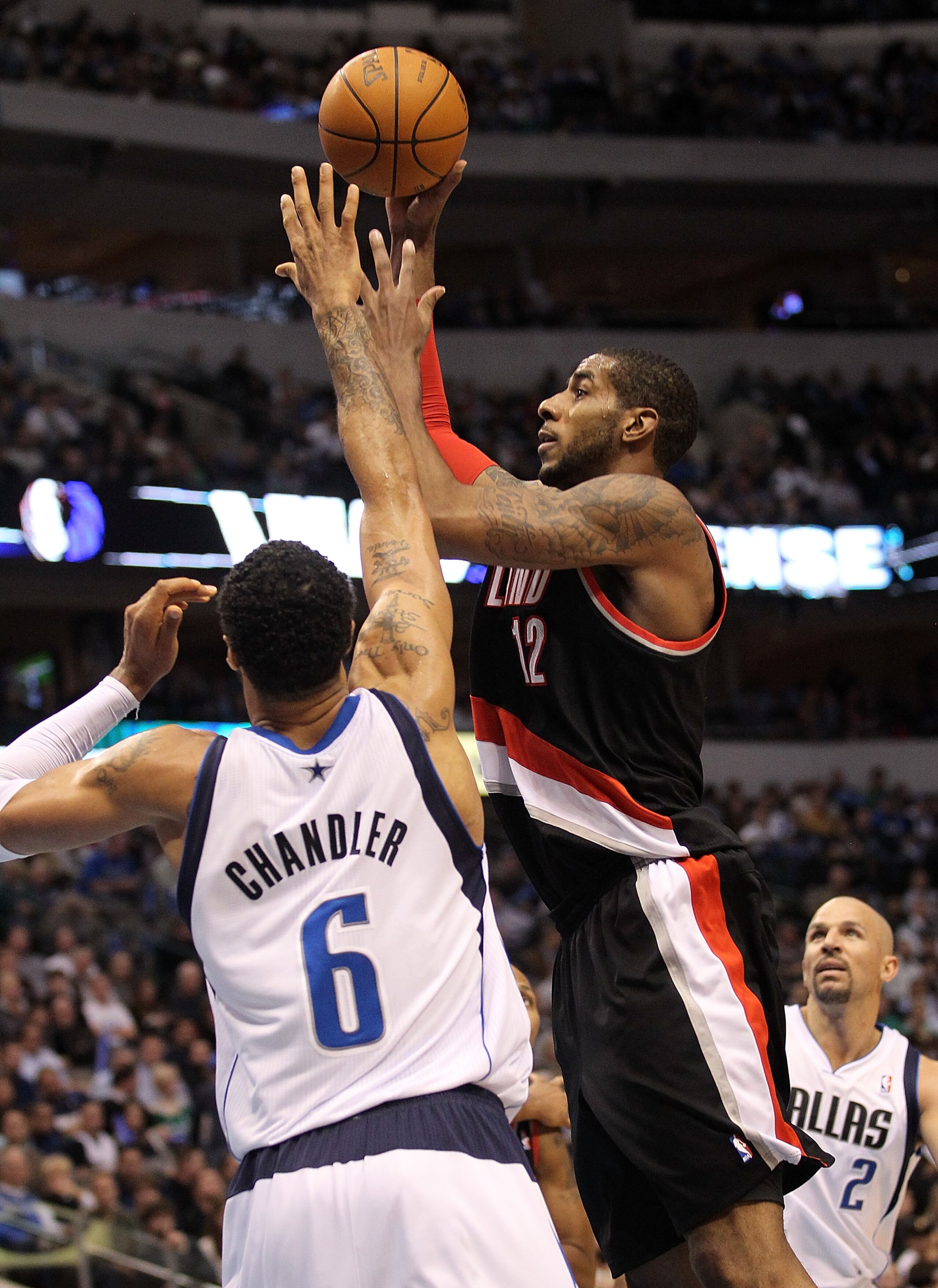 DALLAS, TX - JANUARY 04: Forward LaMarcus Aldridge #12 of the Portland Trail Blazers takes a shot against Tyson Chandler #6 of the Dallas Mavericks at American Airlines Center on January 4, 2011 in Dallas, Texas. NOTE TO USER: User expressly acknowledge DALLAS, TX - JANUARY 04: Forward LaMarcus Aldridge #12 of the Portland Trail Blazers takes a shot against Tyson Chandler #6 of the Dallas Mavericks at American Airlines Center on January 4, 2011 in Dallas, Texas. NOTE TO USER: User expressly acknowledge